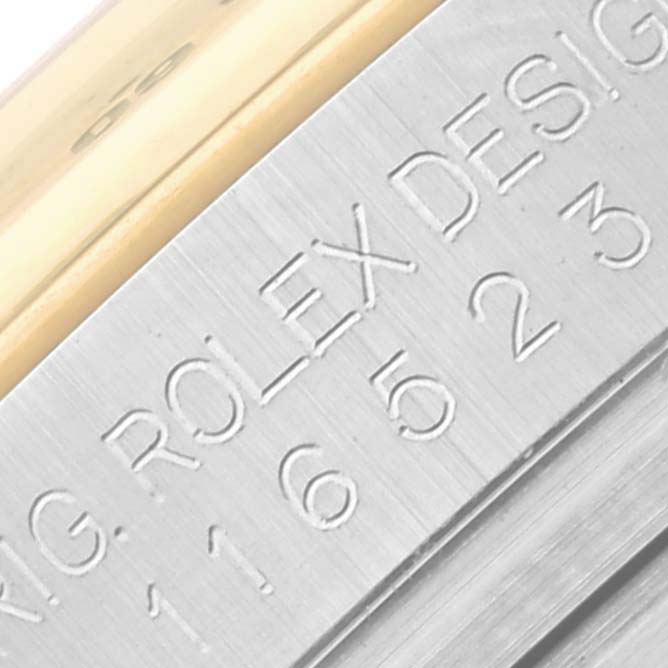 The image shows a close-up angle of the Rolex Daytona 116523 Men's Steel and Gold (two tone) Black Dial 116523 Men's Steel and Gold (two tone) Black Dial model's case side, highlighting the engraved text.