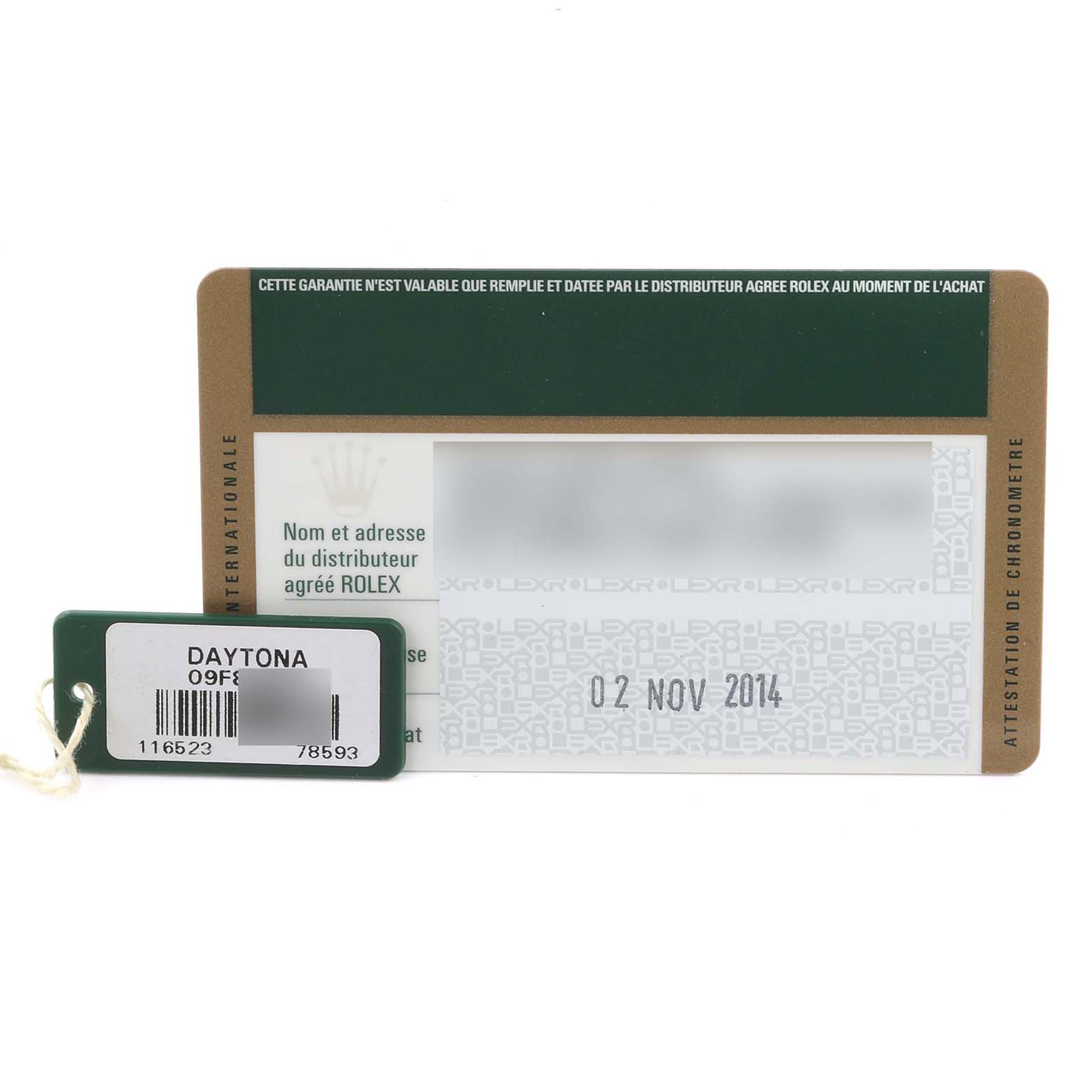 The image shows a warranty card and tag for a Rolex Daytona 116523 Men's Steel and Gold (two tone) Black Dial 116523 Men's Steel and Gold (two tone) Black Dial watch.