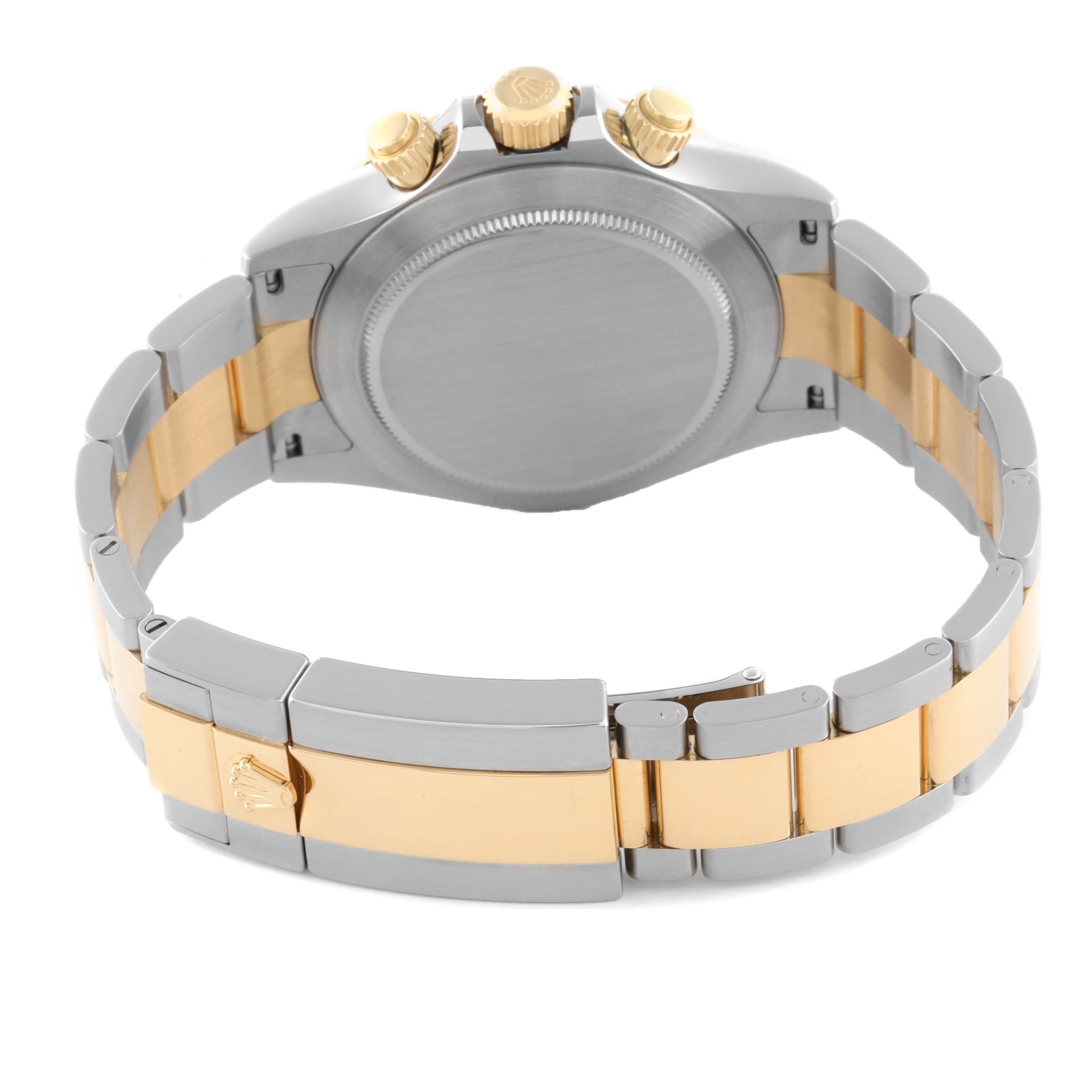 The image shows the back view of a Rolex Daytona 116523 Men's Steel and Gold (two tone) Black Dial 116523 Men's Steel and Gold (two tone) Black Dial, highlighting the case, crown, and two-tone bracelet.