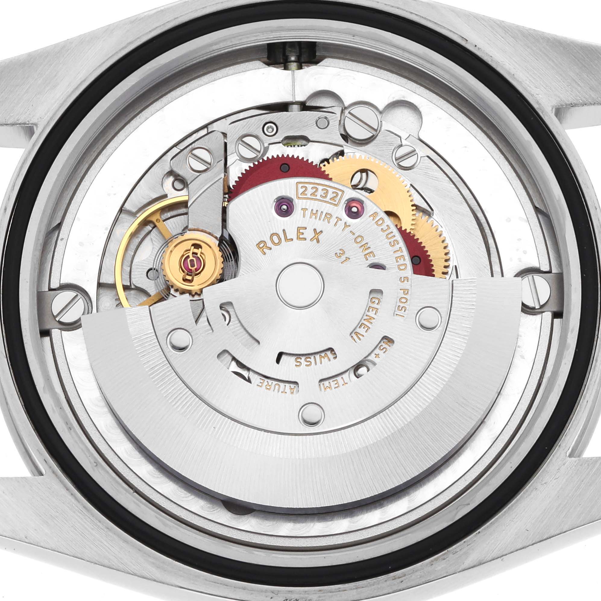 The image shows the inner mechanism of a Rolex Oyster Perpetual 124200 Men
s Stainless Steel Silver Dial watch, highlighting gears and the rotor.