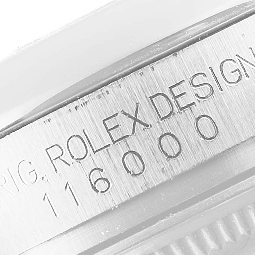 This image shows a close-up of the side of a Rolex Oyster Perpetual 116000 Men's Stainless Steel Silver Dial 116000 Men's Stainless Steel Silver Dial watch, focusing on the engraved model number 116000.