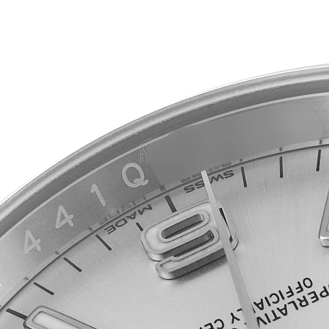 The image shows a close-up of the dial and part of the bezel of a Rolex Oyster Perpetual 116000 Men's Stainless Steel Silver Dial 116000 Men's Stainless Steel Silver Dial watch, highlighting the hour markers and part of the "Swiss Made" text.