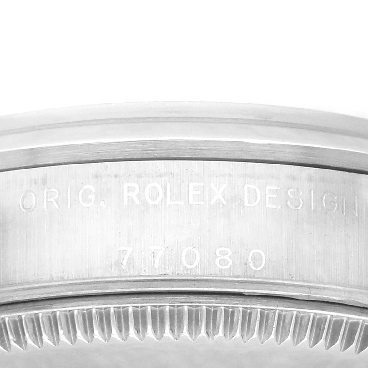 The image shows a close-up of the engraved side and bezel edge of a mid-size Rolex watch.
