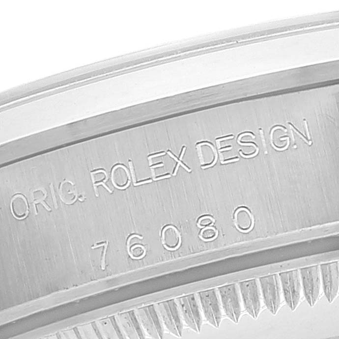 This image shows a close-up of the case edge with engravings on a Rolex Oyster Perpetual 76080 Women
s Stainless Steel Silver Dial 76080 Women
s Stainless Steel Silver Dial watch, including the model number 76080.