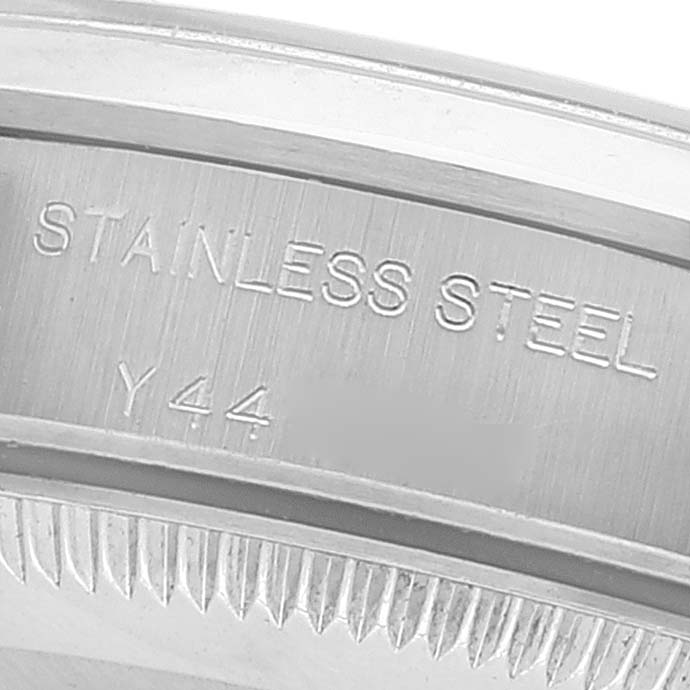 This image shows a close-up of the stainless steel casing and engravings on a Rolex Oyster Perpetual 76080 Women
s Stainless Steel Silver Dial 76080 Women
s Stainless Steel Silver Dial watch.