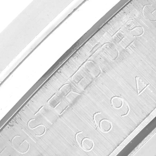 The image shows a close-up angle of the engraved side of the Rolex Vintage Collection 6694 Men's Stainless Steel Silver Dial 6694 Men's Stainless Steel Silver Dial watch case.