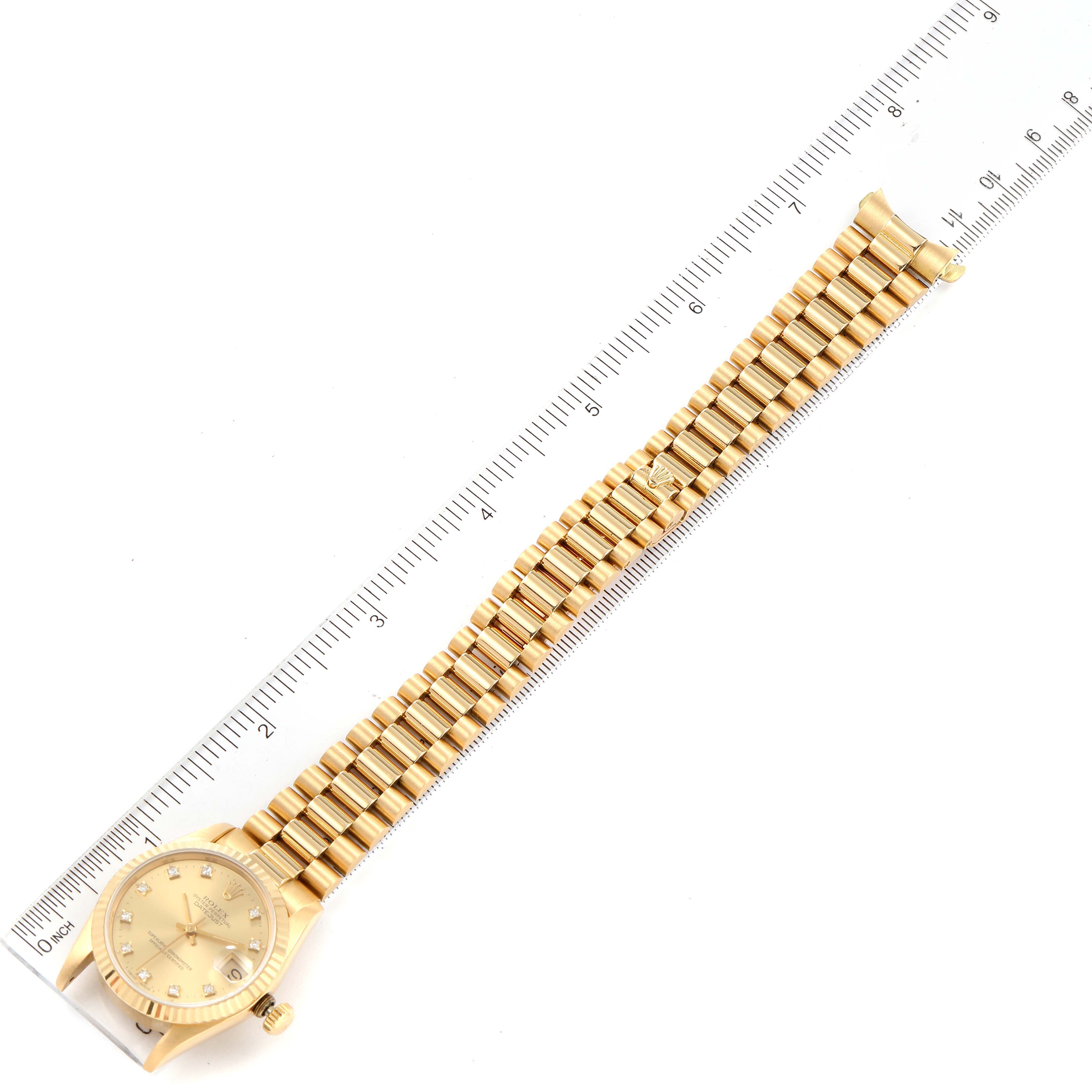 The image shows a top-down view of a Rolex President 68278 Women's Yellow Gold Champagne Dial 68278 Women's Yellow Gold Champagne Dial model watch, with the entire bracelet and face visible next to a ruler.