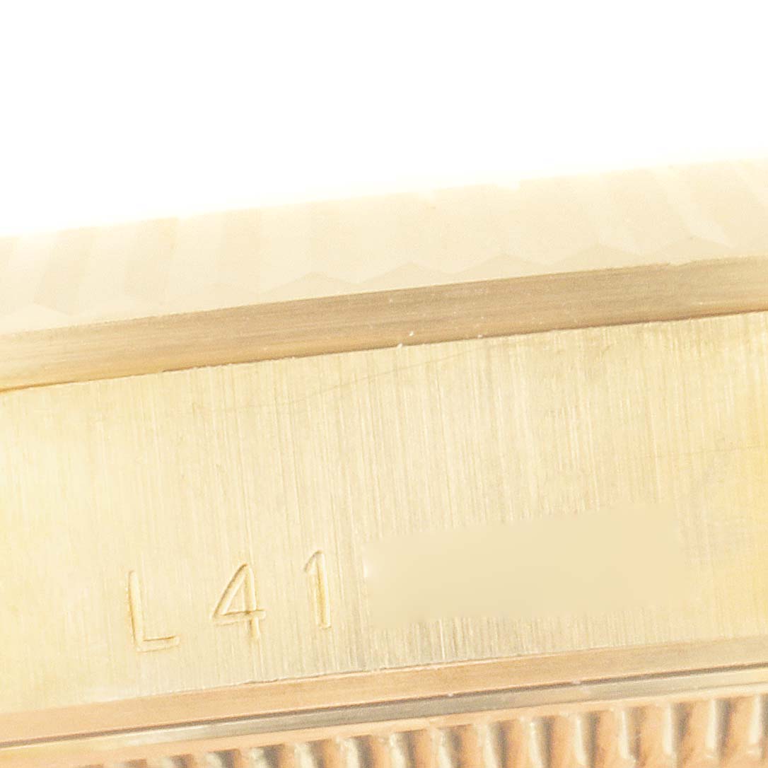 The image shows a close-up of the side of a Rolex President 68278 Women's Yellow Gold Champagne Dial 68278 Women's Yellow Gold Champagne Dial watch, highlighting part of the case with engraved markings.