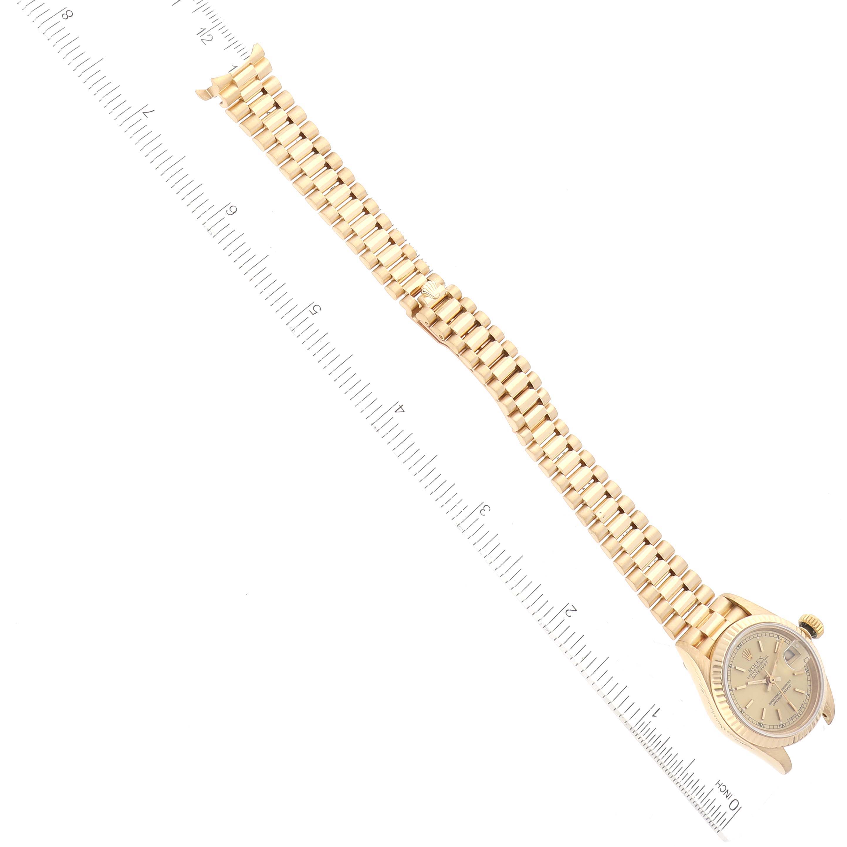 The image shows the full front view of a Rolex President 69178 Women's Yellow Gold Champagne Dial 69178 Women's Yellow Gold Champagne Dial model watch, including the face and the bracelet, with a ruler for scale.