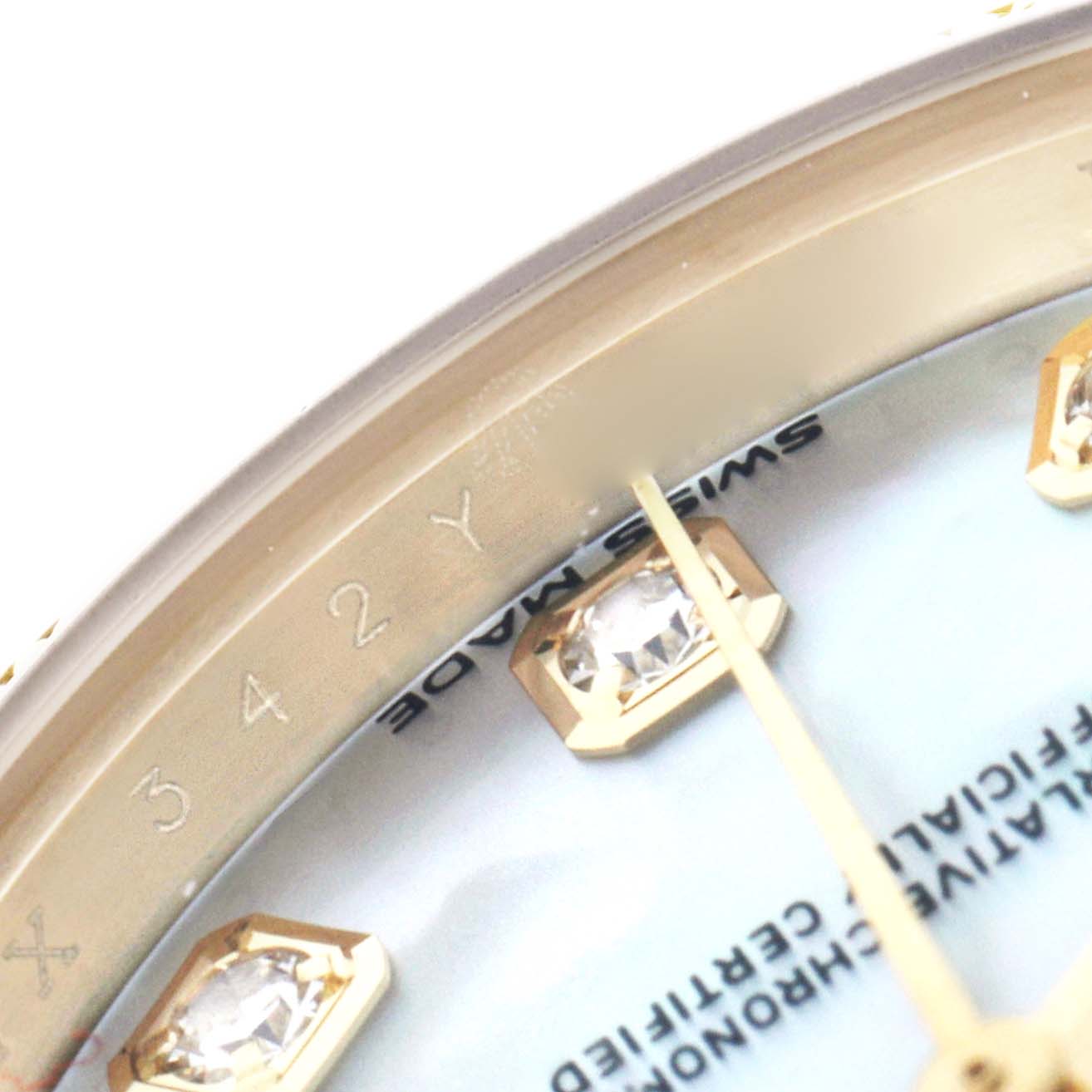 The image shows a close-up of the Rolex President 279138 Women
s Yellow Gold Mother of Pearl Dial watch face, highlighting the diamond hour markers and part of the dial.