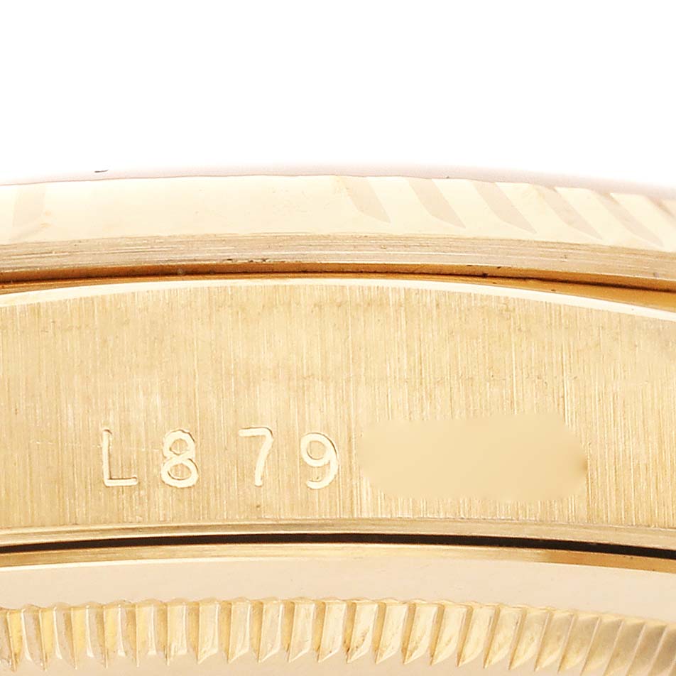 The image shows the gold side profile and part of the fluted bezel of a Rolex President 18238 Men
s Yellow Gold Champagne Dial 18238 Men
s Yellow Gold Champagne Dial model, focusing on the serial number.