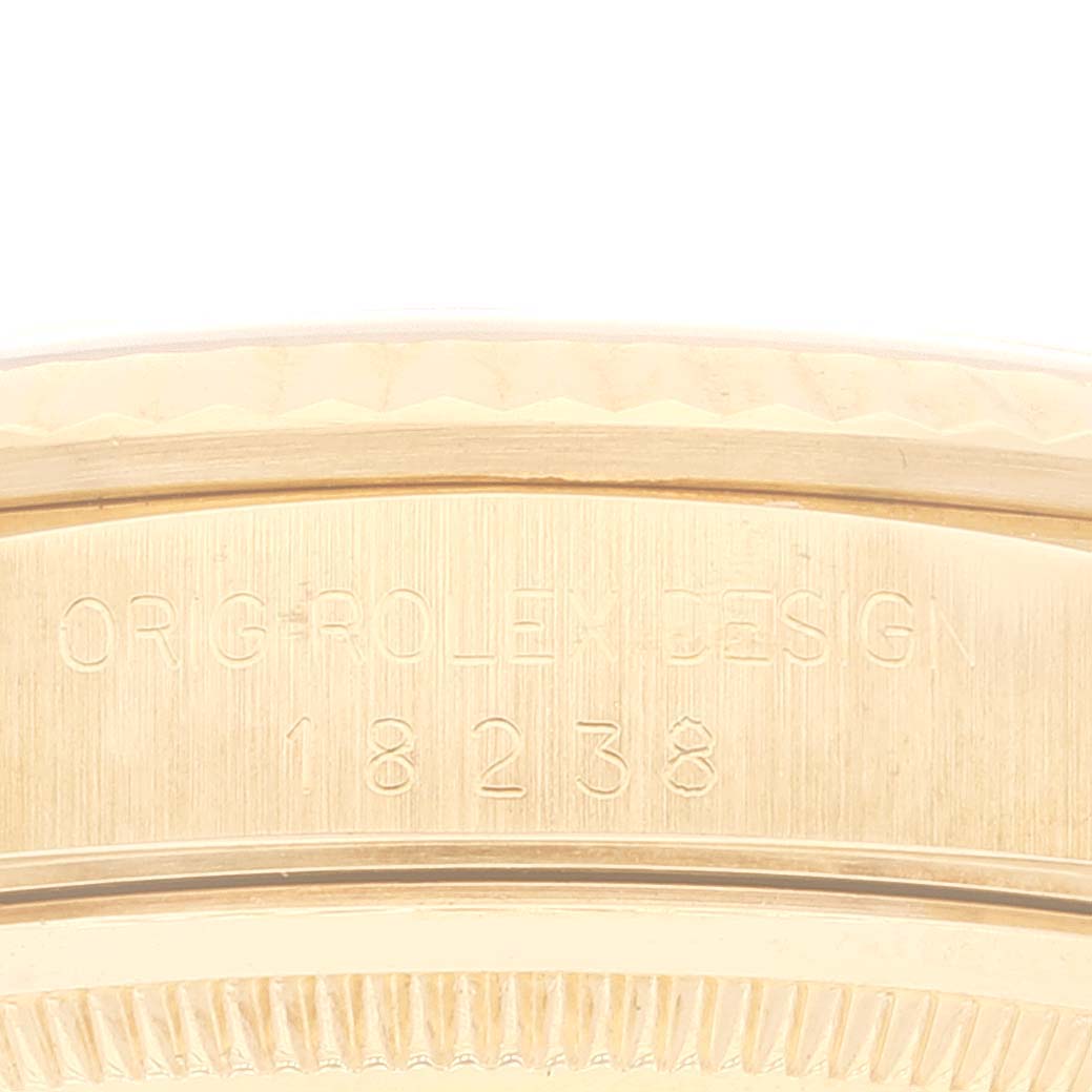 This close-up shows the engraved side of the case of a Rolex President 18238 Men's Yellow Gold Champagne Dial 18238 Men's Yellow Gold Champagne Dial model, indicating its design and model number (18238).