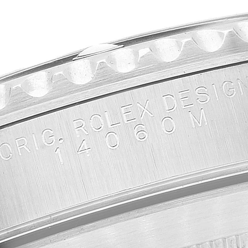 The image shows a close-up of the side casing with engravings on a Rolex Submariner 14060 Men
s Stainless Steel Black Dial 14060 Men
s Stainless Steel Black Dial watch.
