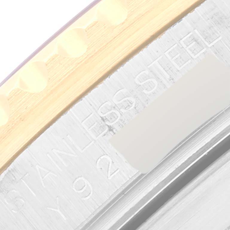 The image shows a close-up of the bezel and part of the stainless steel case on a Rolex Submariner 16613 Men's Steel and Gold (two tone) Blue Dial 16613 Men's Steel and Gold (two tone) Blue Dial.