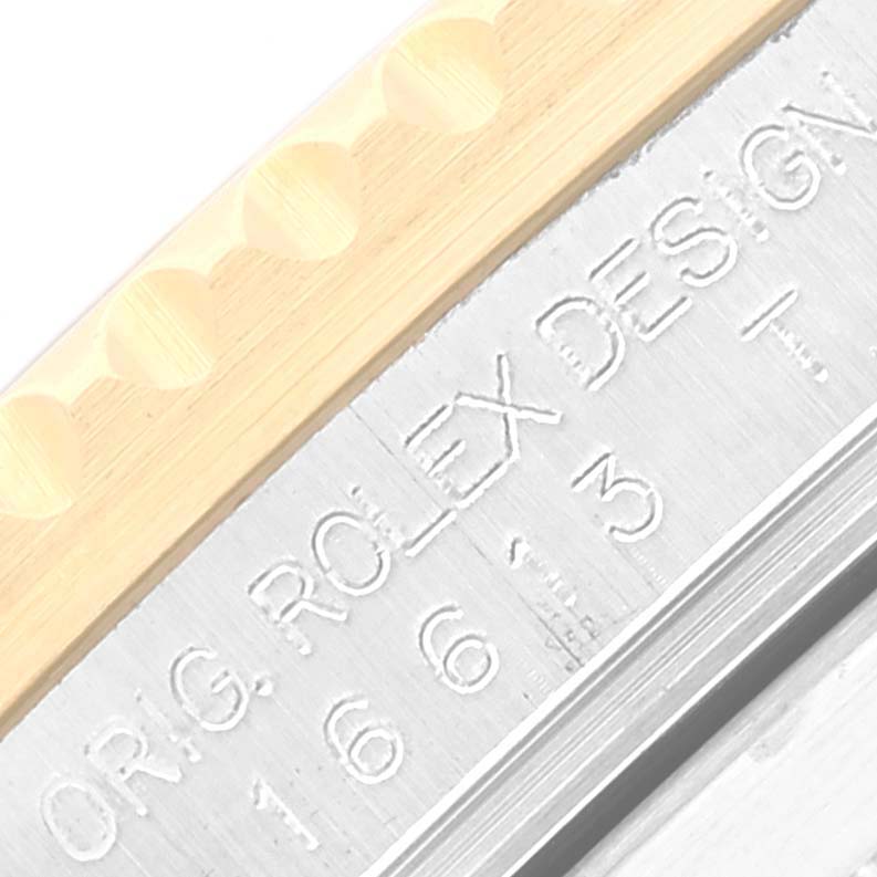 A close-up of the bezel and engraved details of the Rolex Submariner 16613 Men's Steel and Gold (two tone) Blue Dial 16613 Men's Steel and Gold (two tone) Blue Dial watch is shown.