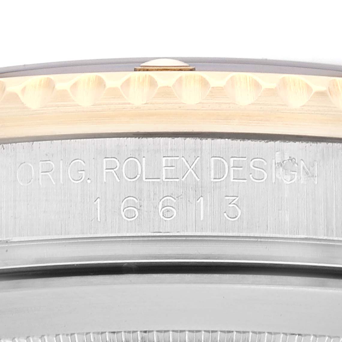 The image shows a close-up of the side engraving on a Rolex Submariner 16613 Men's Steel and Gold (two tone) Black Dial 16613 Men's Steel and Gold (two tone) Black Dial, model number 16613, featuring "ORIG. ROLEX DESIGN."