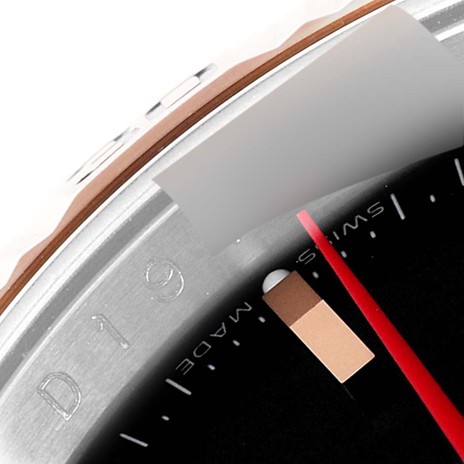 The image shows a close-up view of the bezel and dial of a Rolex Turn-o-Graph 116261 Men
s Steel and Gold (two tone) Black Dial 116261 Men
s Steel and Gold (two tone) Black Dial watch, displaying part of the bezel, minute markers, and the second hand.