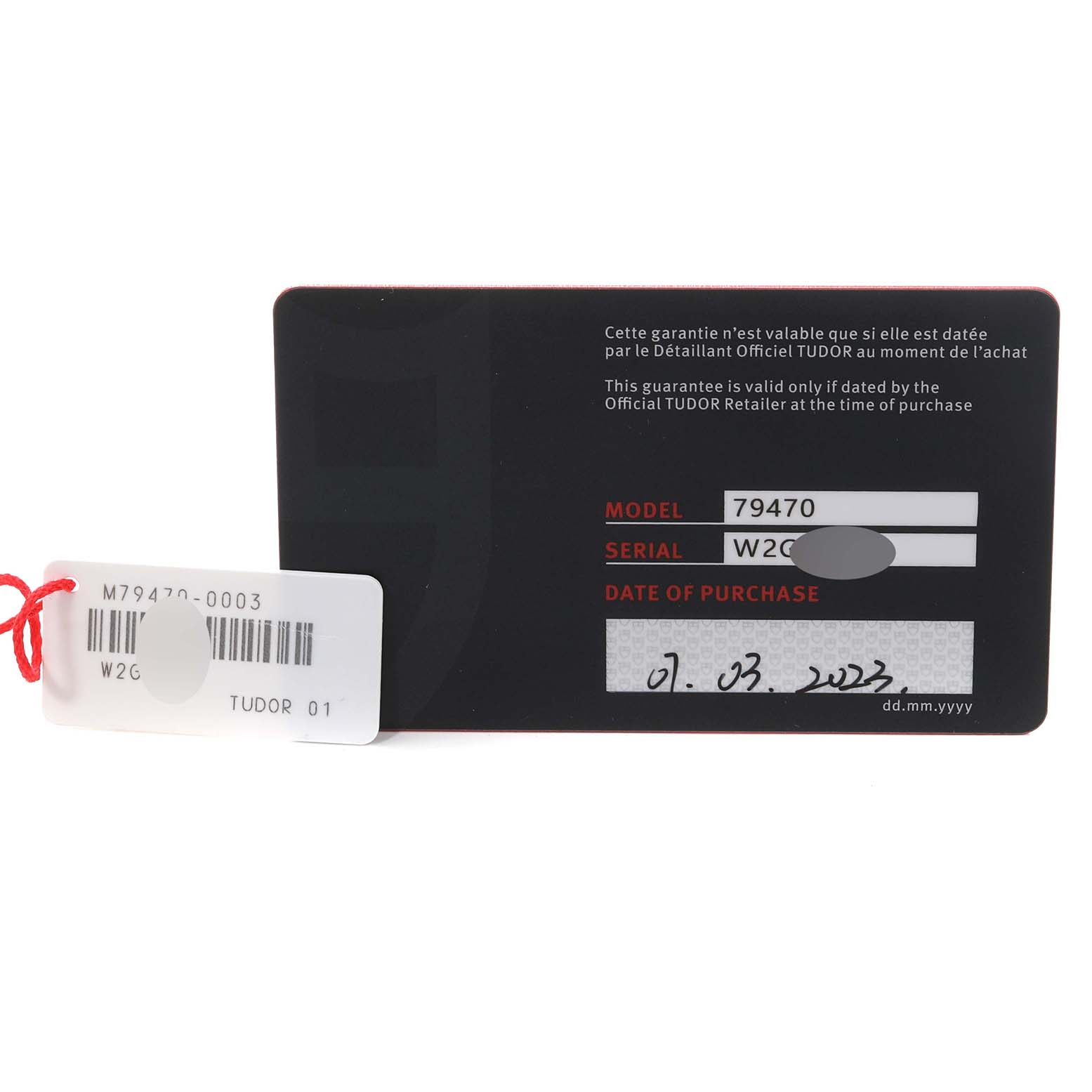 The image shows the warranty card and a tag for the Tudor Heritage Black Bay M79470-0003 Men
s Stainless Steel Black Dial M79470-0003 Men
s Stainless Steel Black Dial model 79470.