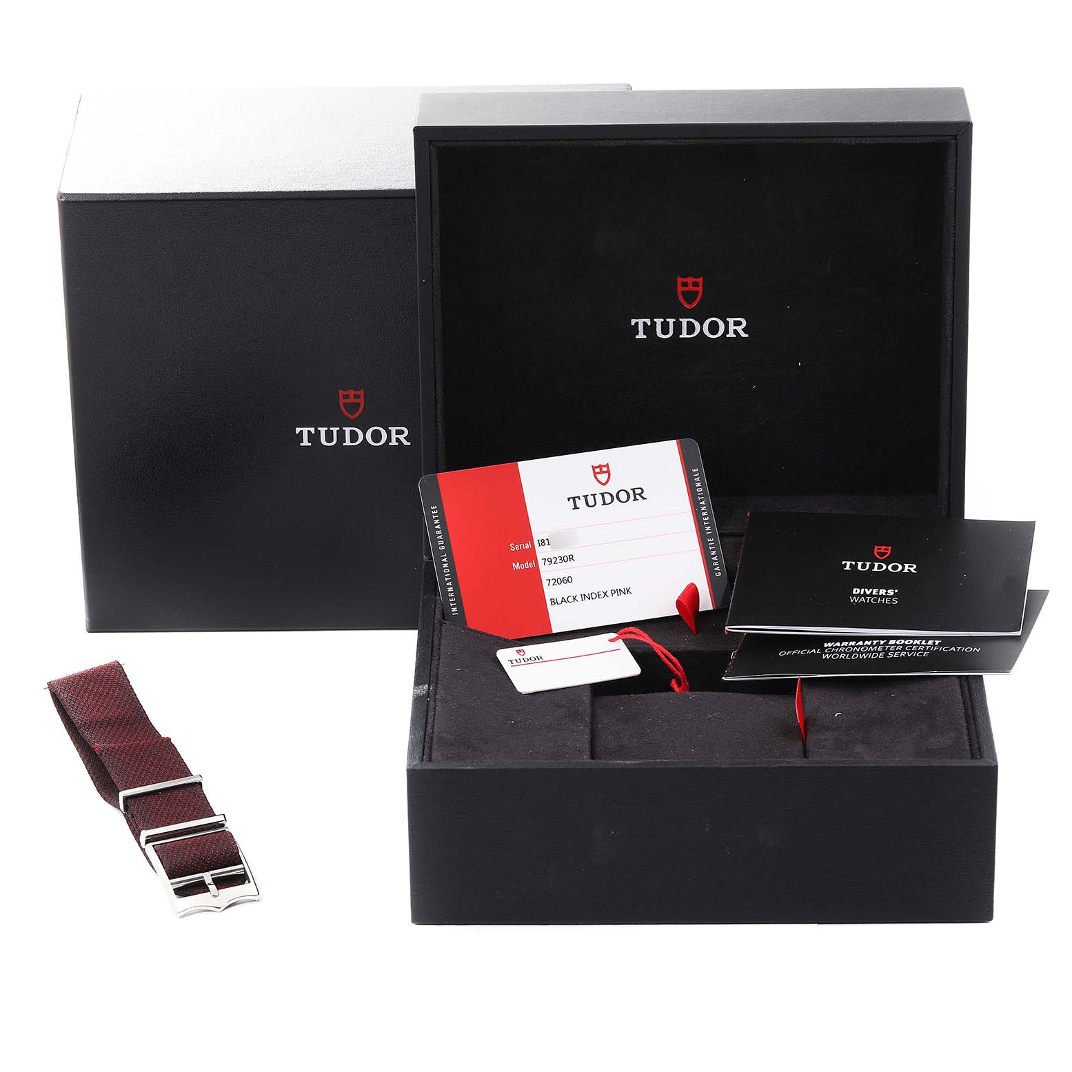 The image shows the packaging, documentation, and an extra strap for a Tudor Heritage Black Bay 79230R Men's Stainless Steel Black Dial 79230R Men's Stainless Steel Black Dial watch.