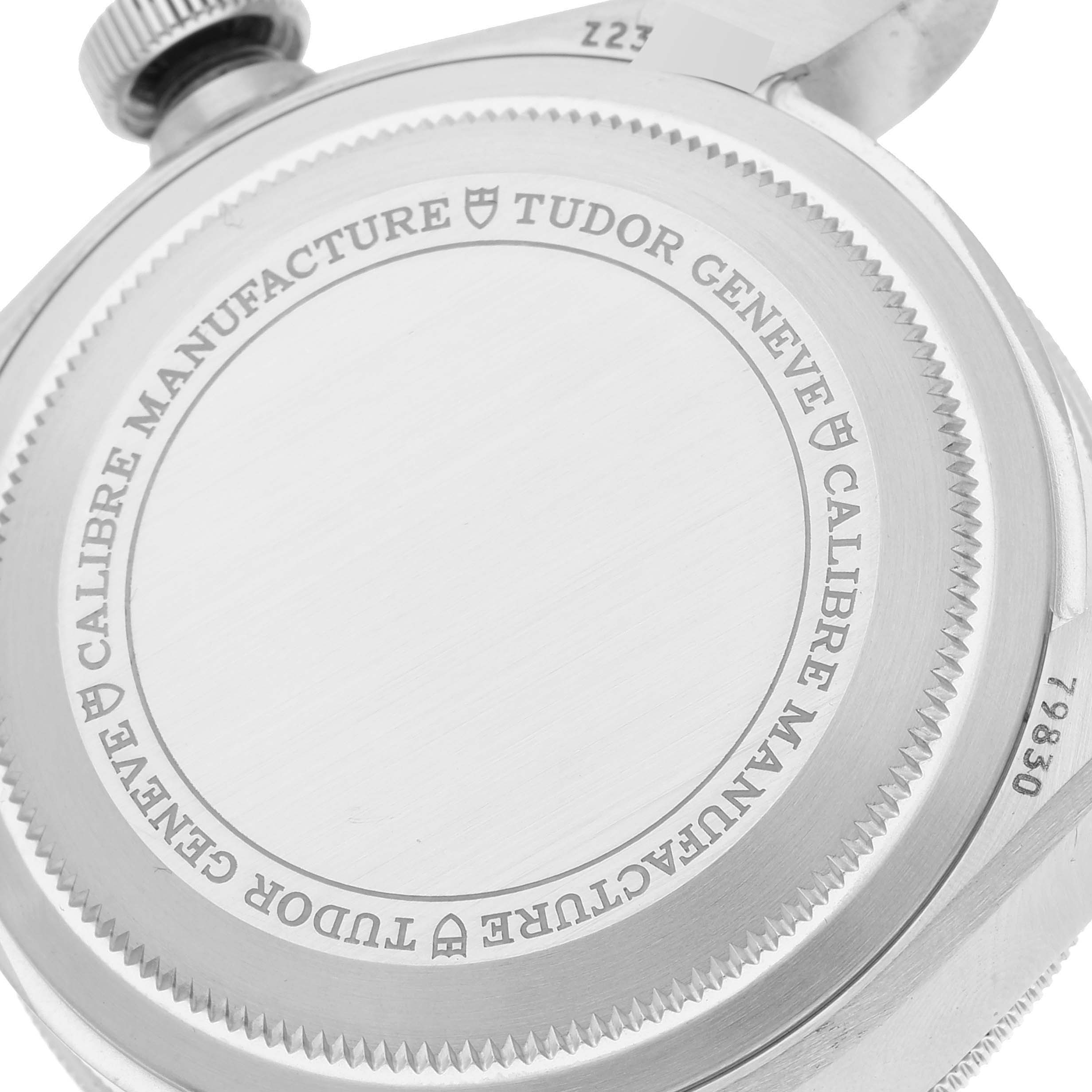 The image shows the back casing and crown of the Tudor Heritage Black Bay 79830RB Men
s Stainless Steel Black Dial 79830RB Men
s Stainless Steel Black Dial watch, highlighting the engraved text.