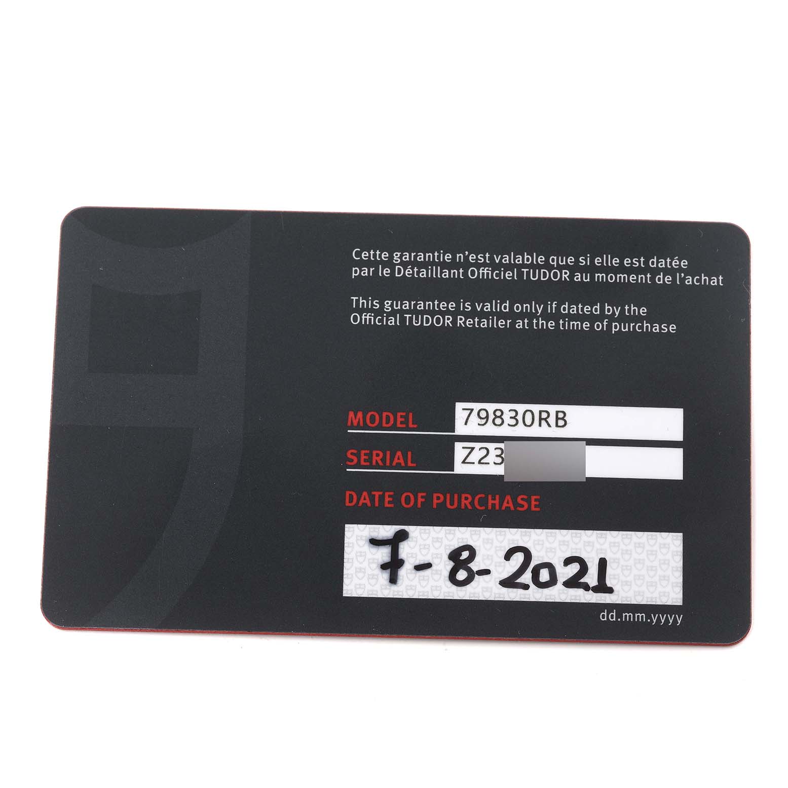 This is an image of the warranty card for a Tudor Heritage Black Bay 79830RB Men
s Stainless Steel Black Dial 79830RB Men
s Stainless Steel Black Dial model 79830RB, showing the serial number and date of purchase.