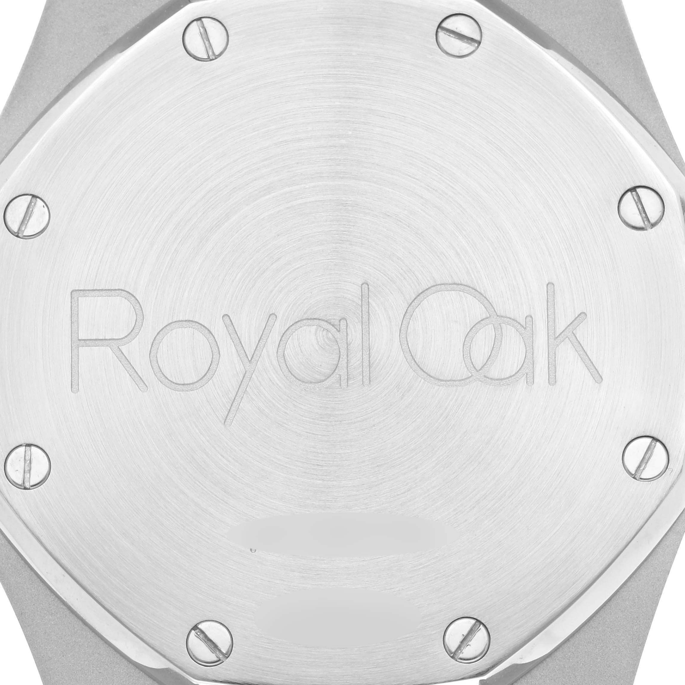 The image shows the back of an Audemars Piguet Royal Oak 26300ST.OO.1110ST.07 Men's Stainless Steel Blue Dial watch, highlighting the engraved logo and screws.