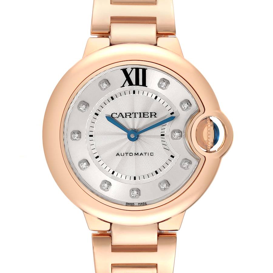 The Cartier Ballon Bleu watch is shown head-on, highlighting its round dial, numerals, and metal band.