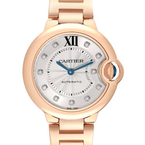 The Cartier Ballon Bleu watch is shown from a front angle, displaying the face, crown, and part of the bracelet.