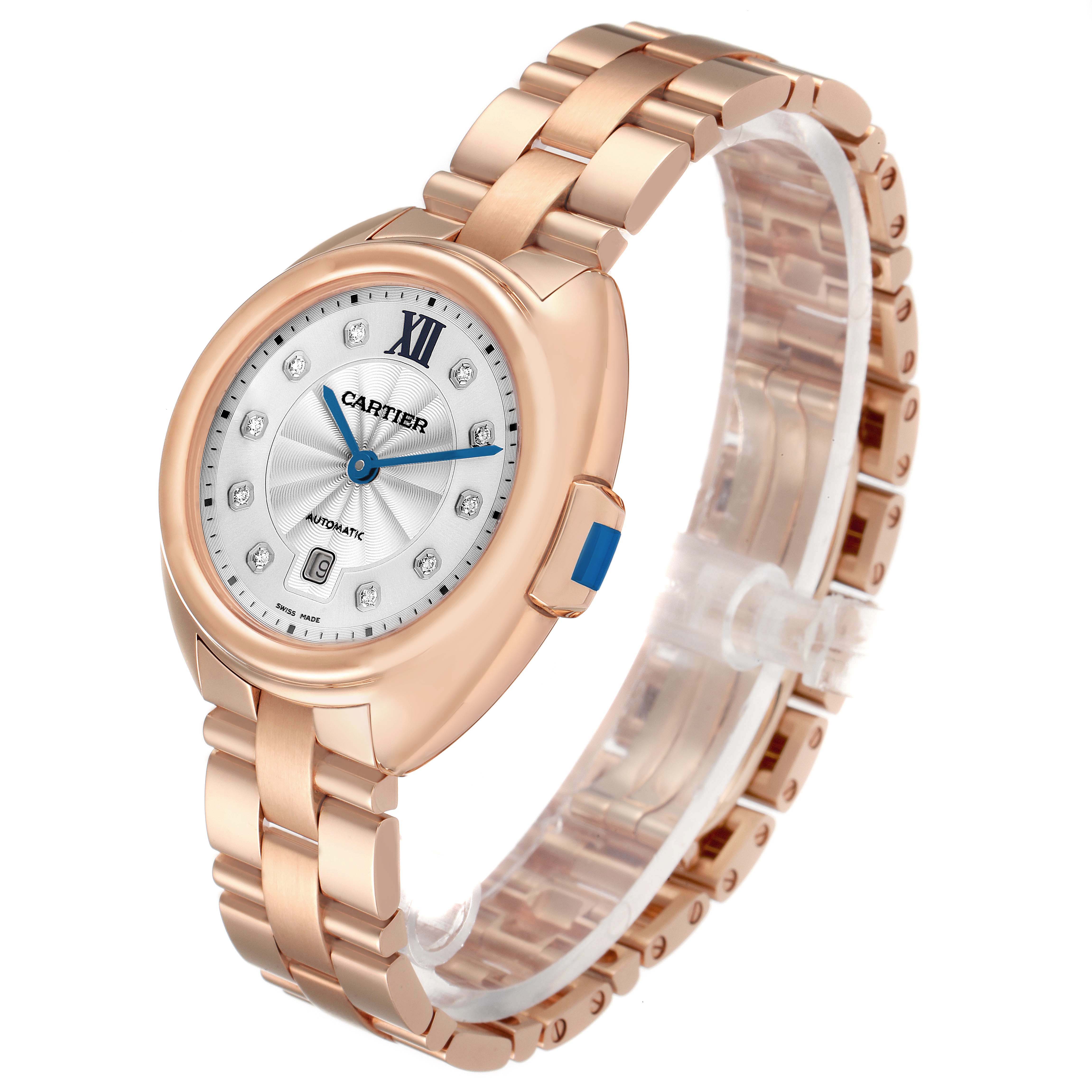 The Cartier Clé watch is shown from an angled side view, highlighting the rose gold band and round diamond-set dial.