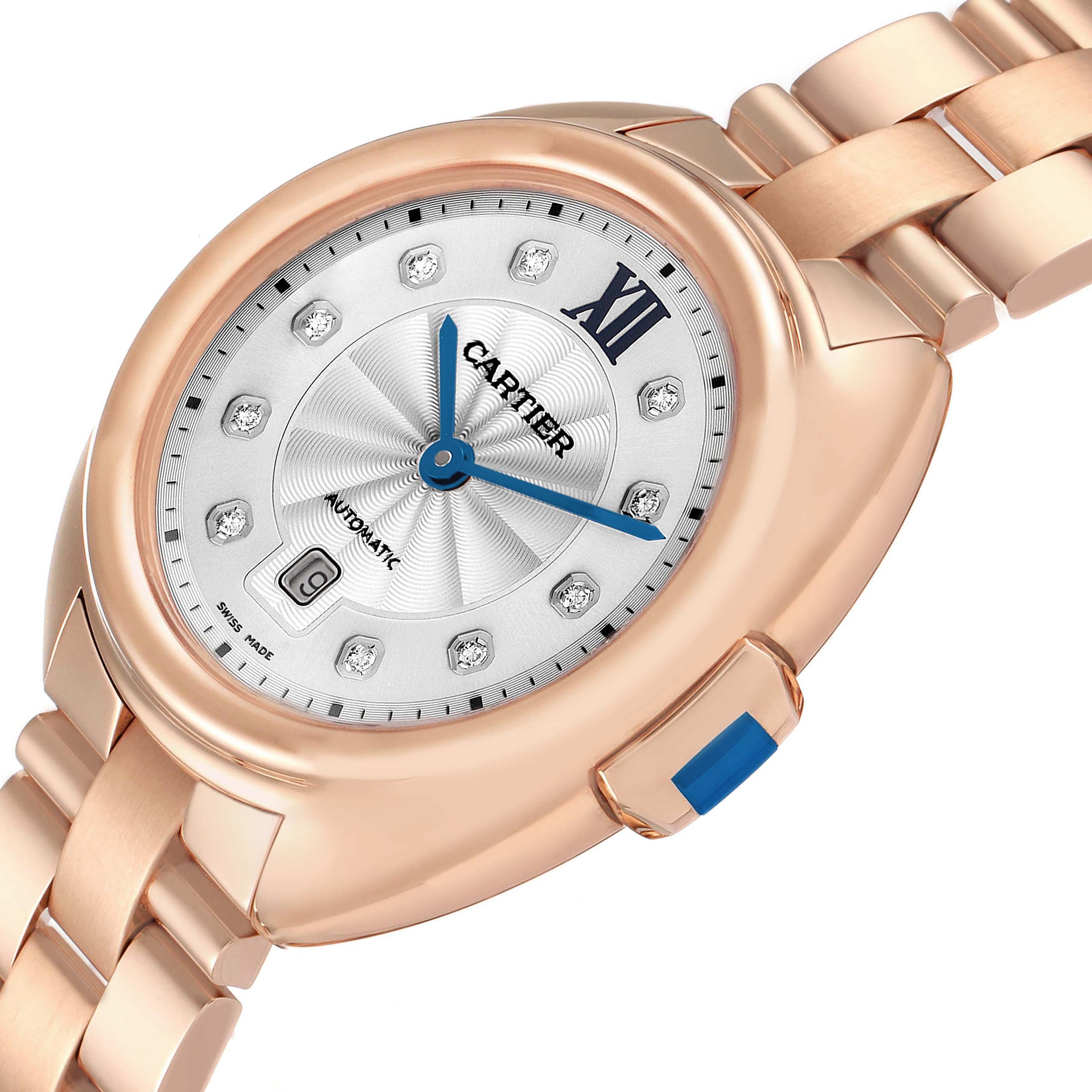 The Cartier Clé watch is shown at an angled view, highlighting the watch face, bezel, and part of the bracelet.