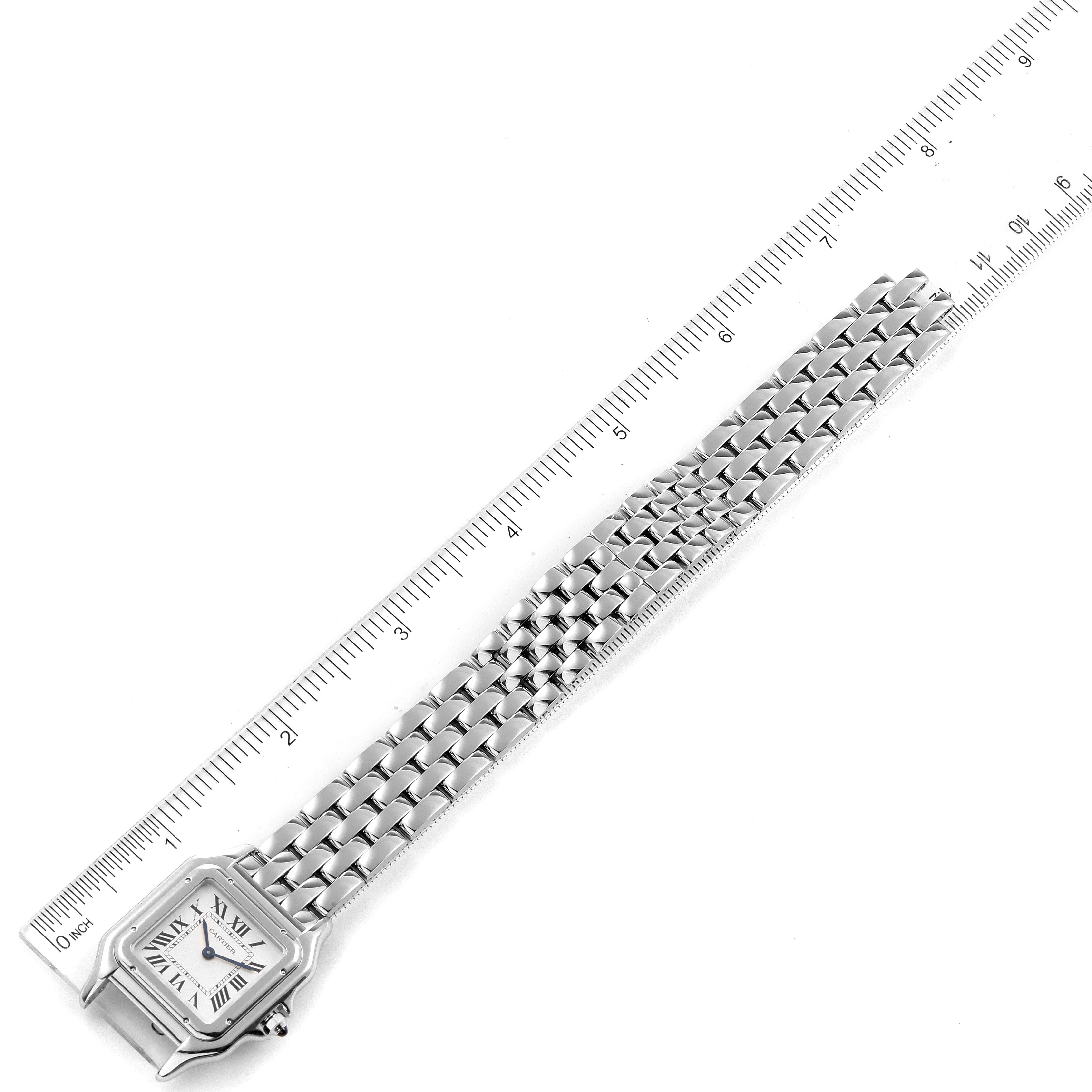 The image shows an overhead view of a Cartier Panthere WSPN0007 Women's Stainless Steel Silver Dial WSPN0007 Women's Stainless Steel Silver Dial watch alongside a ruler for scale.