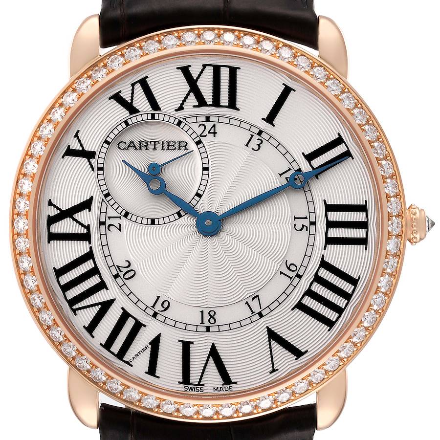 The Cartier Ronde WR007001 Men's Rose Gold Silver Dial watch is shown from a front angle, featuring Roman numerals, blue hands, and a diamond-encrusted bezel.