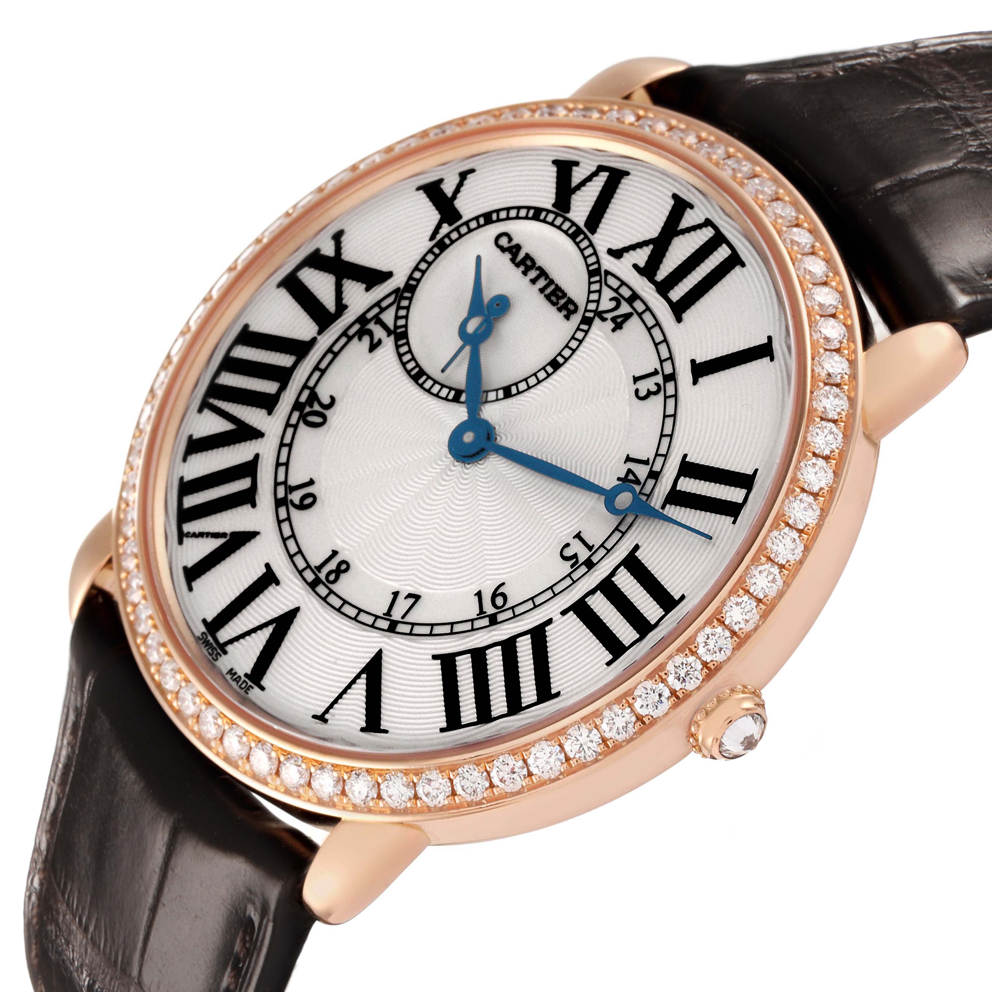 The Cartier Ronde WR007001 Men's Rose Gold Silver Dial watch is shown at a three-quarter angle, highlighting its diamond bezel, Roman numerals, and leather strap.