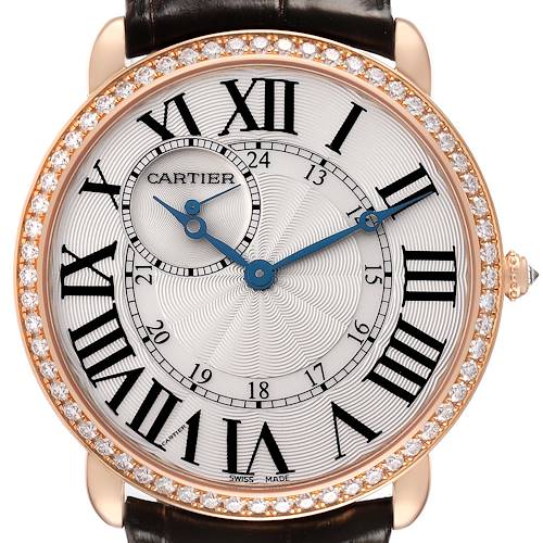 The Cartier Ronde WR007001 Men's Rose Gold Silver Dial watch is shown from a front angle, highlighting its Roman numerals, blue hands, diamond bezel, and leather strap.