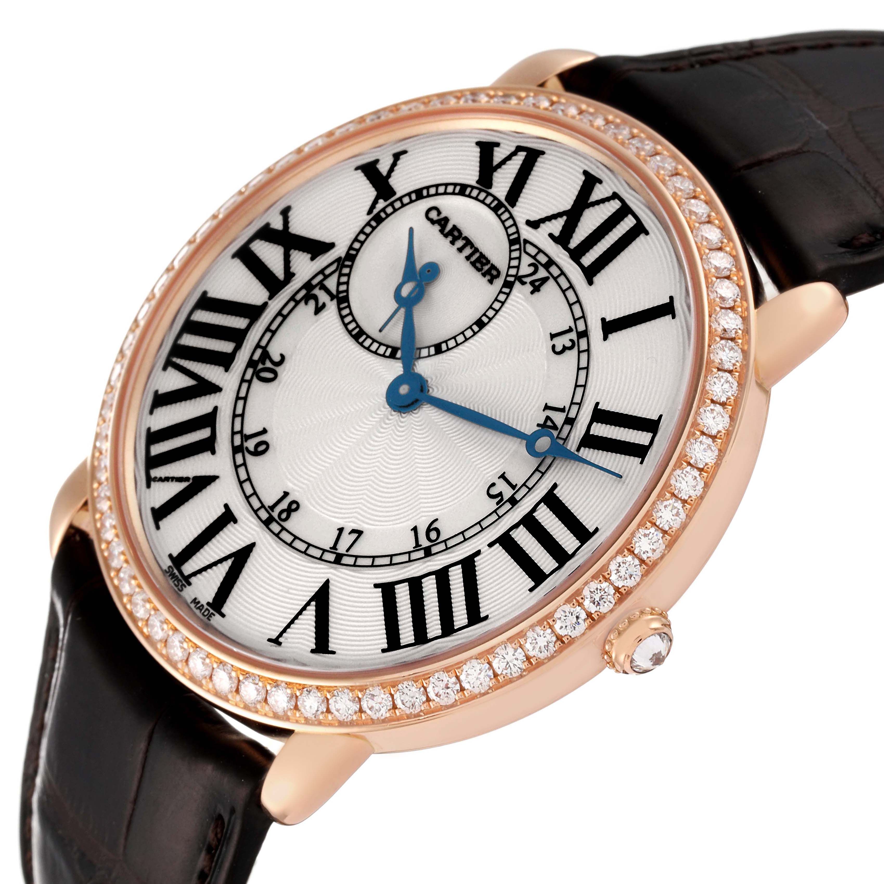 The Cartier Ronde WR007001 Men's Rose Gold Silver Dial watch is shown at a slight angle, highlighting the diamond-studded bezel, Roman numerals, and blue hands.