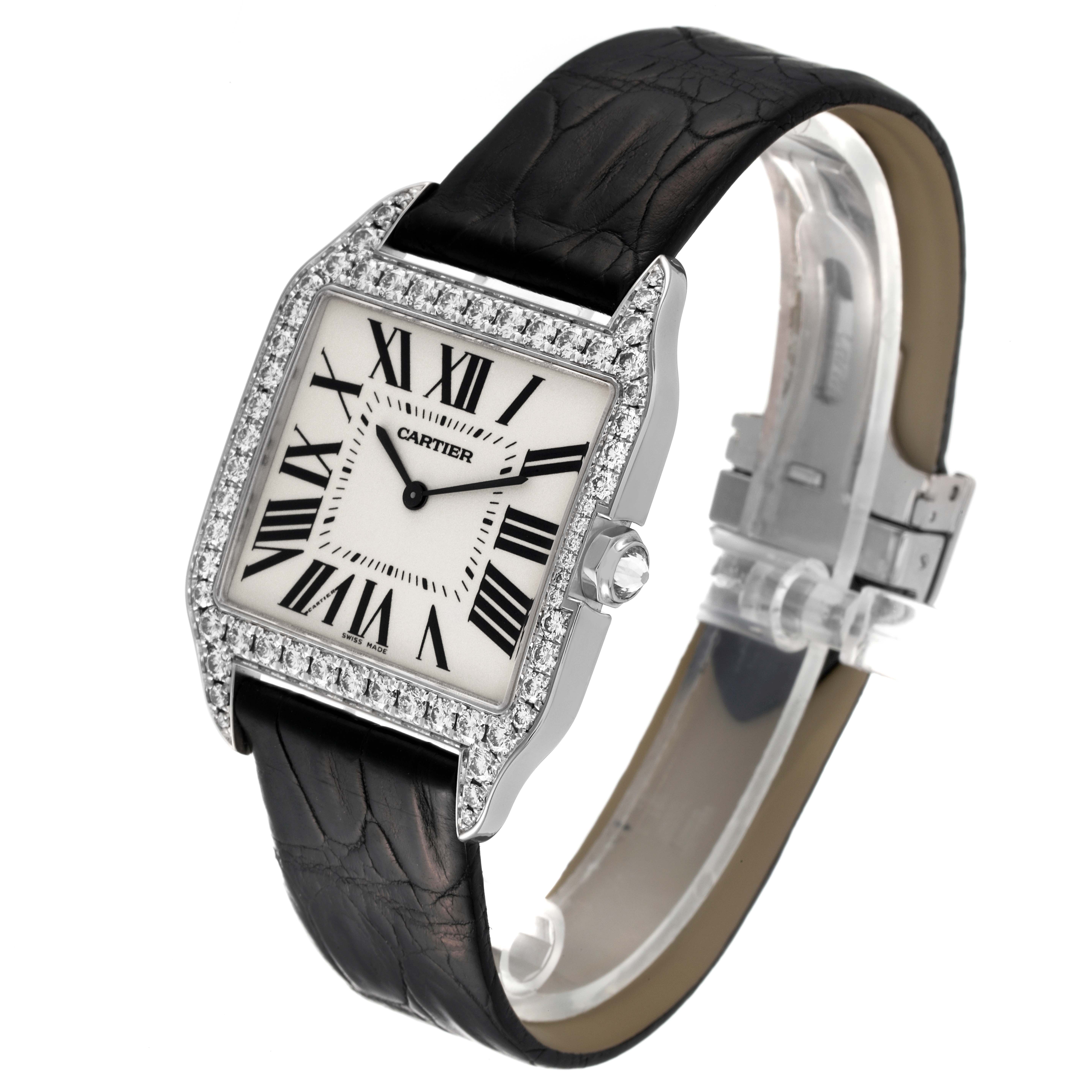 The image shows a Santos Dumont Cartier watch at a slight angle, highlighting its diamond-encrusted bezel, leather strap, and face.