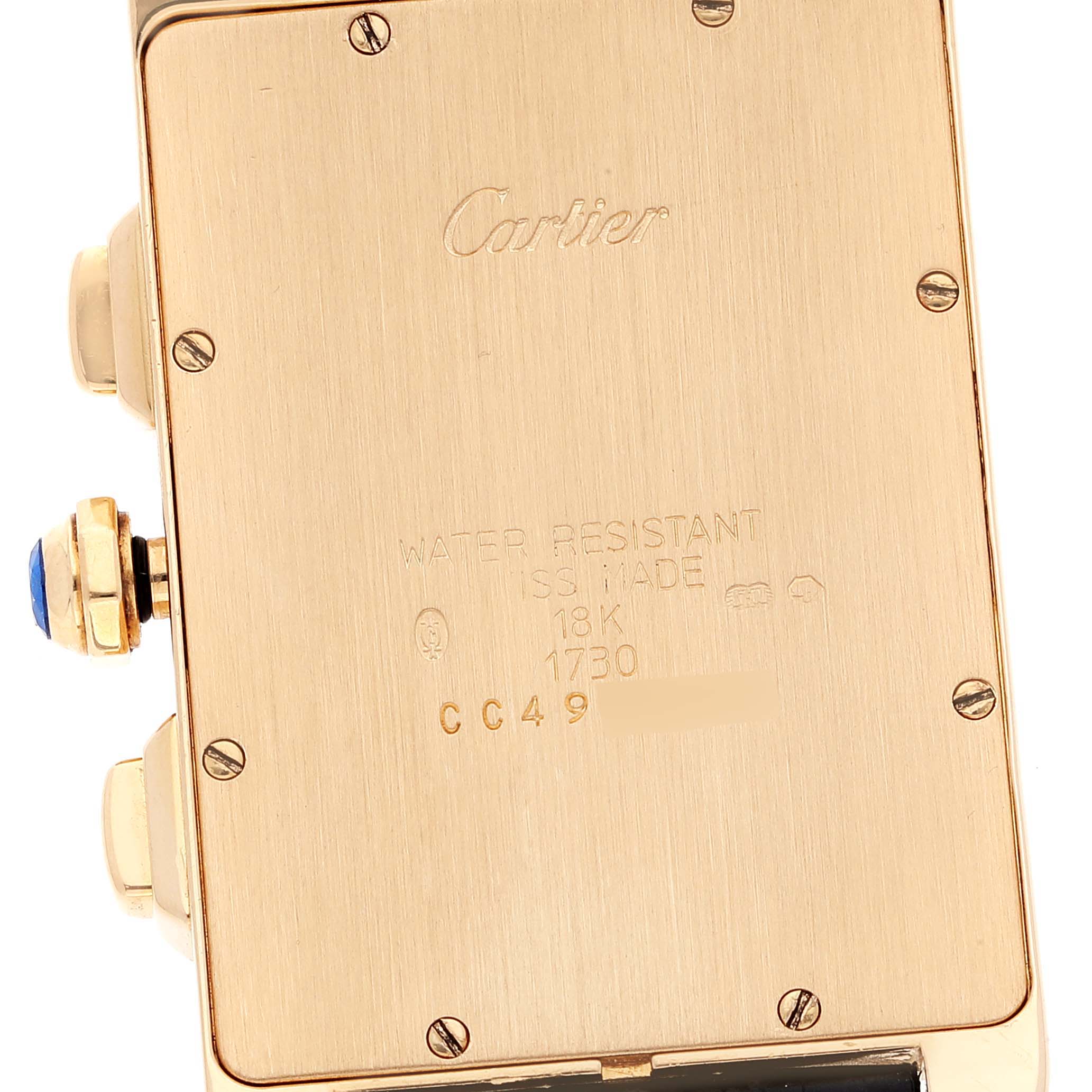 The image shows the case back of a Cartier Tank Américaine watch, highlighting its engravings and screws.