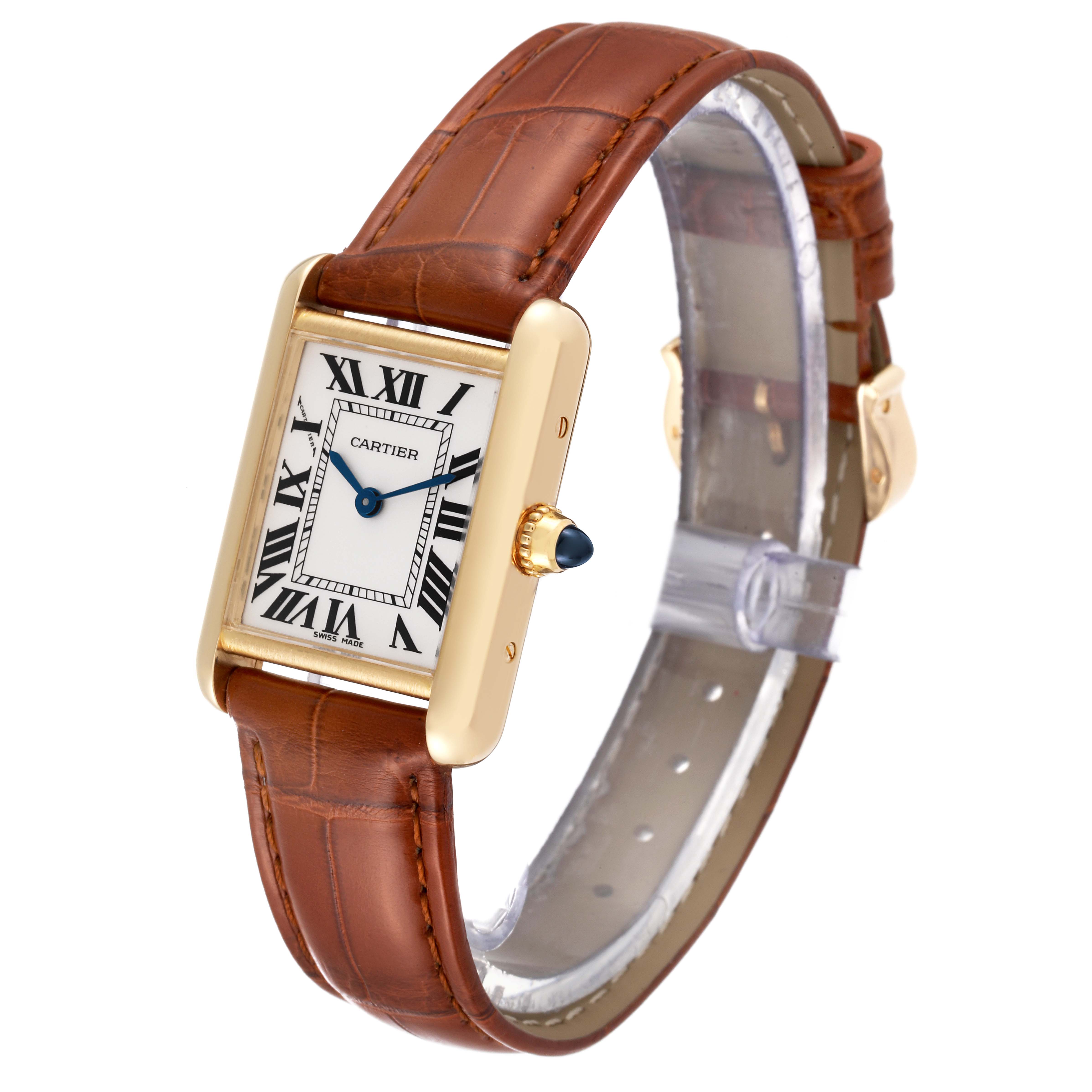The Cartier Tank Louis W1529856 Women
s Yellow Gold Silver Dial W1529856 Women
s Yellow Gold Silver Dial watch is shown at a three-quarter angle, displaying its rectangular face, gold case, and brown leather strap.
