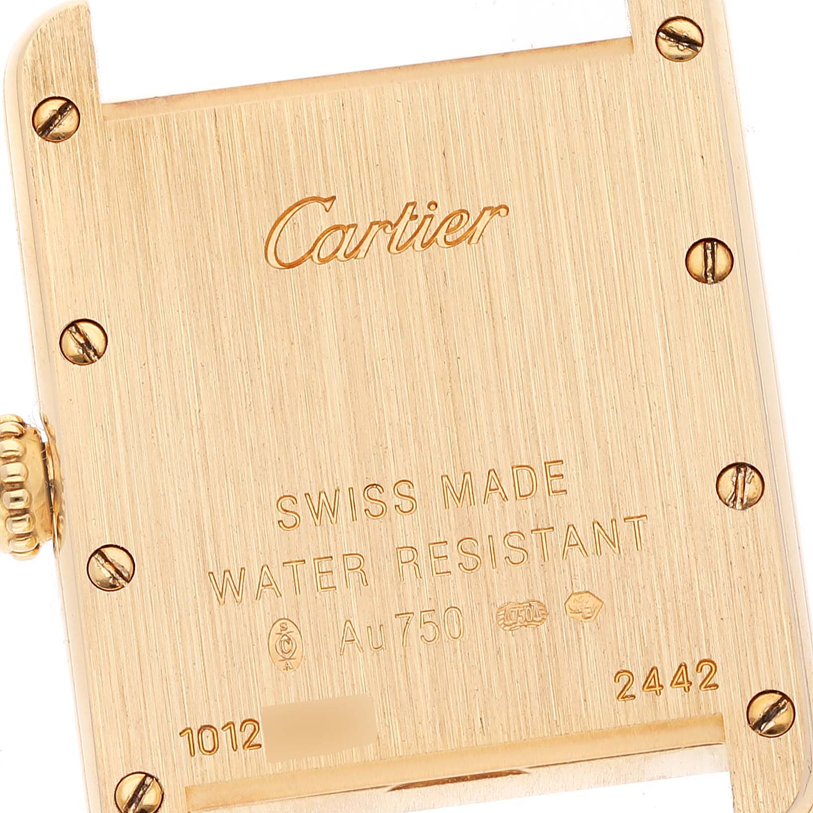 The image shows the back case of a Cartier Tank Louis W1529856 Women
s Yellow Gold Silver Dial W1529856 Women
s Yellow Gold Silver Dial watch, displaying engravings and screws.
