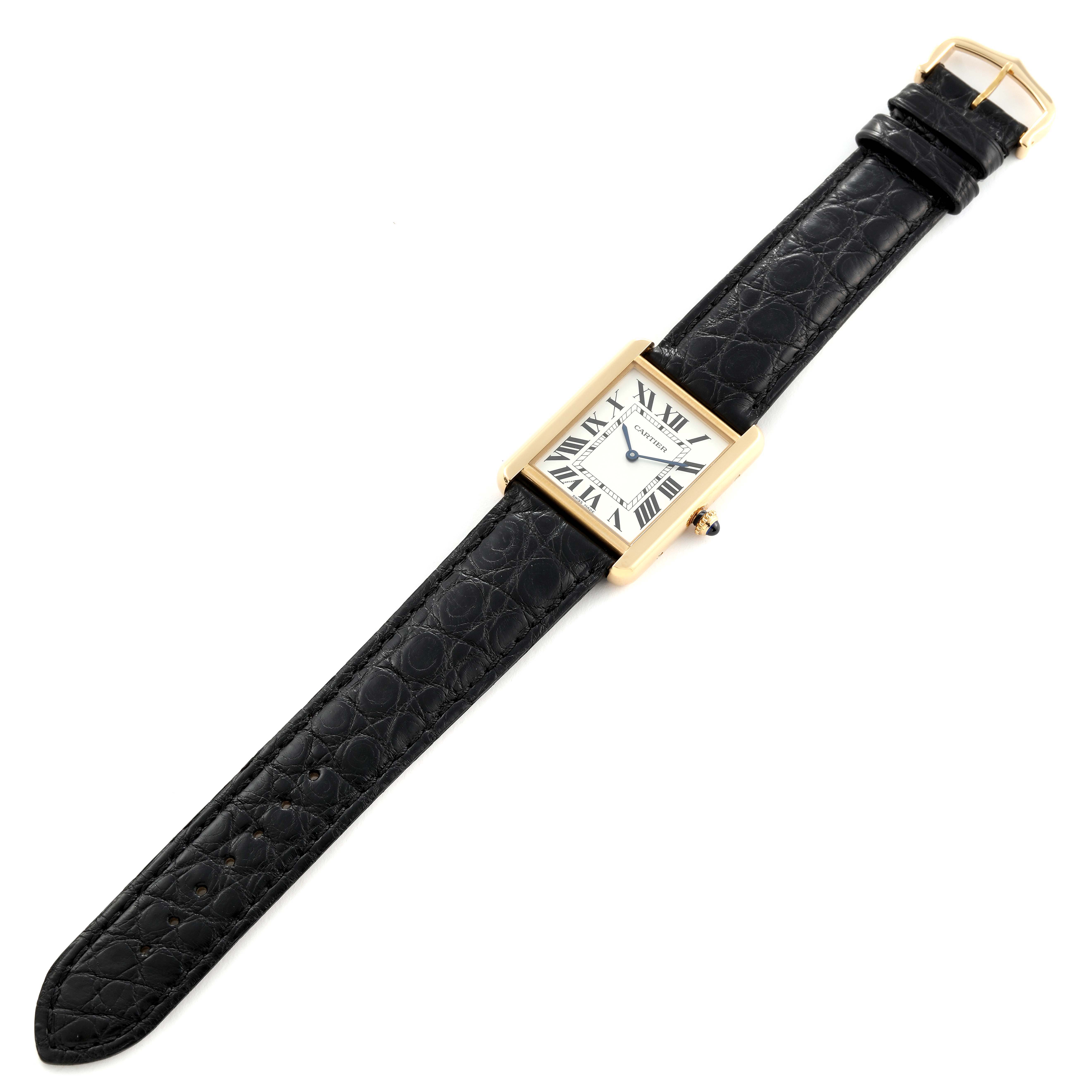 The image shows a top view of a Cartier Tank Solo W5200004 Men
s Yellow Gold Silver Dial W5200004 Men
s Yellow Gold Silver Dial watch, highlighting its face, strap, and buckle.