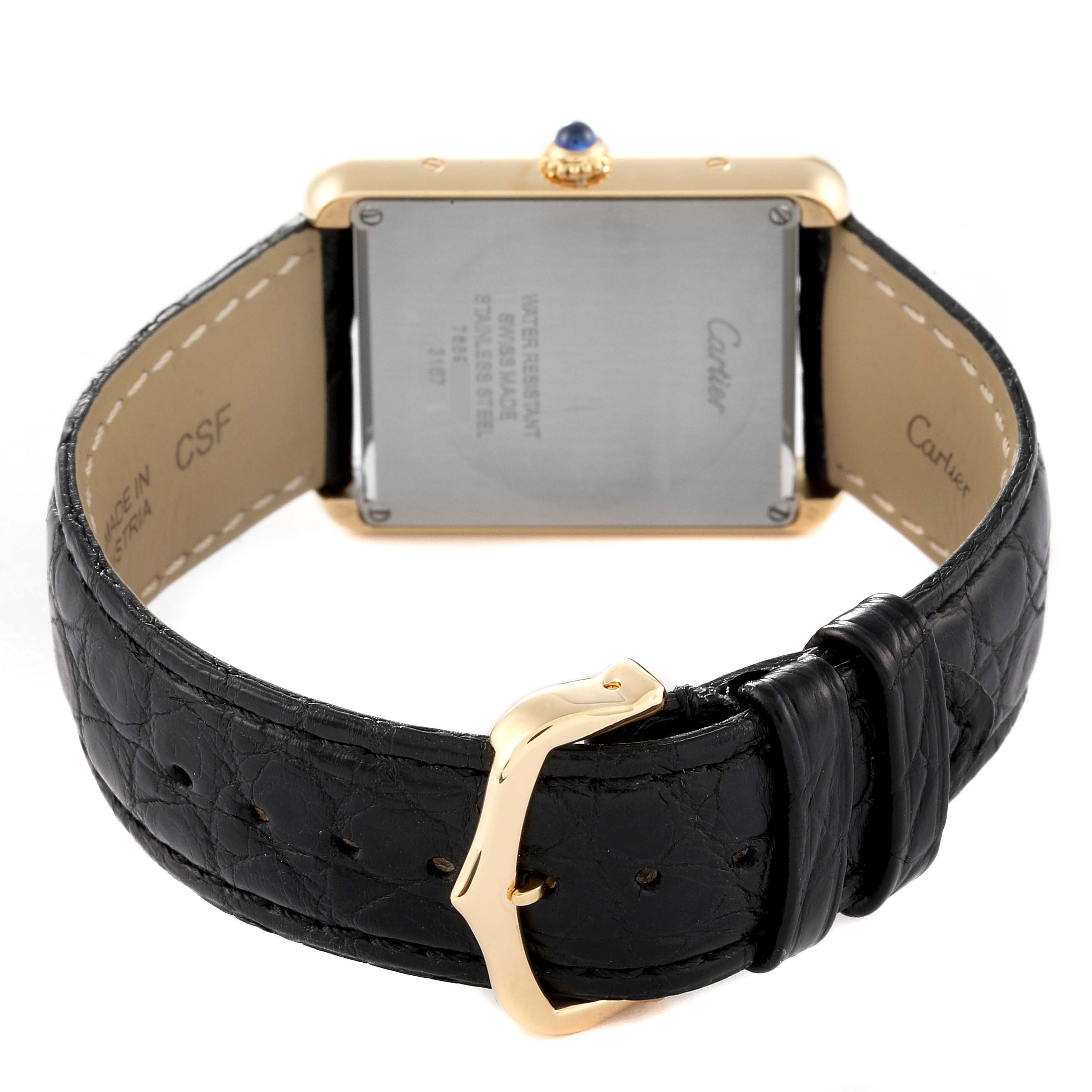 The image shows the back view of a Cartier Tank Solo W5200004 Men
s Yellow Gold Silver Dial W5200004 Men
s Yellow Gold Silver Dial watch with a black leather strap and gold-tone buckle.