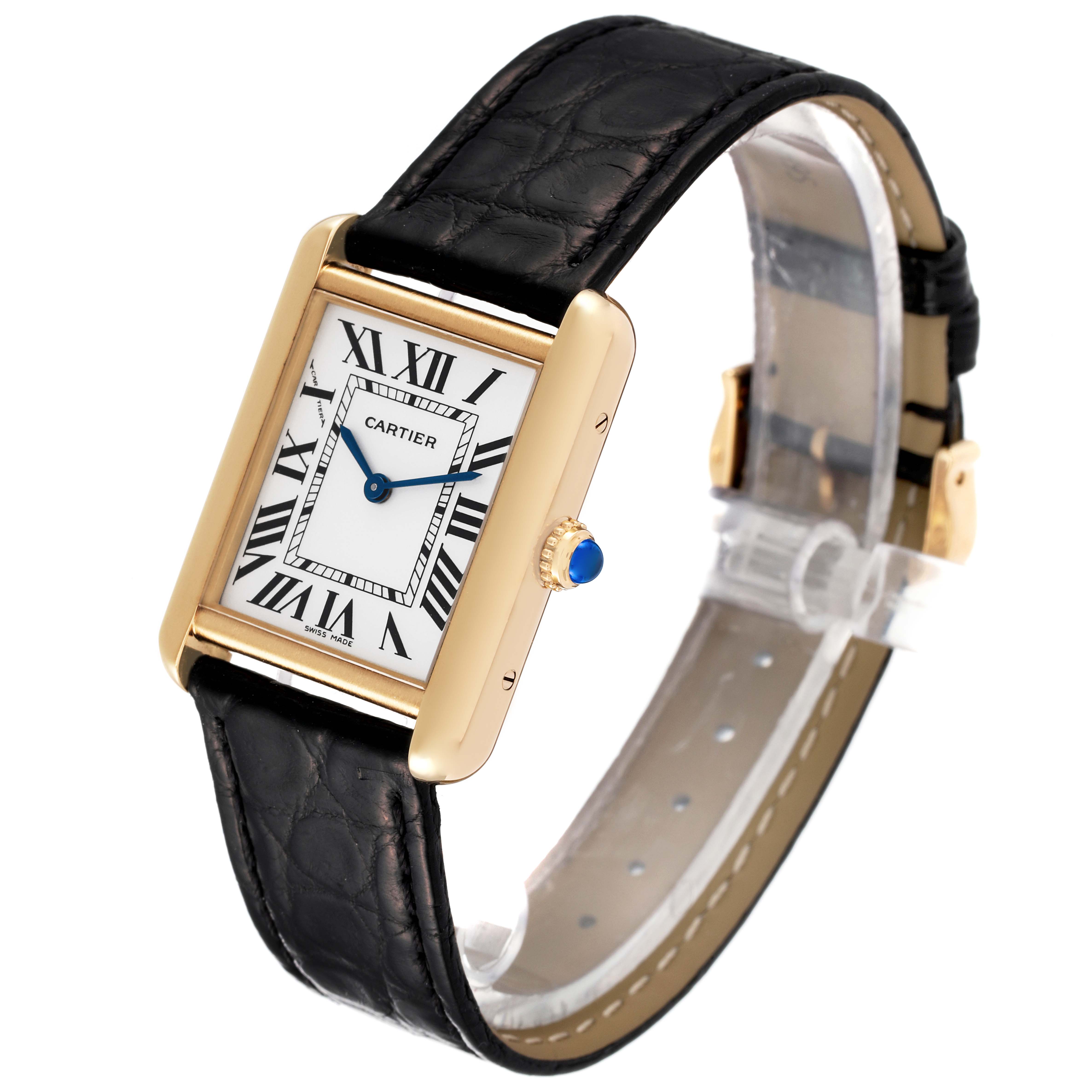 The Cartier Tank Solo W1018755 Women's Yellow Gold Silver Dial W1018755 Women's Yellow Gold Silver Dial watch is shown at an angle highlighting the face, gold case, black leather strap, and blue cabochon crown.