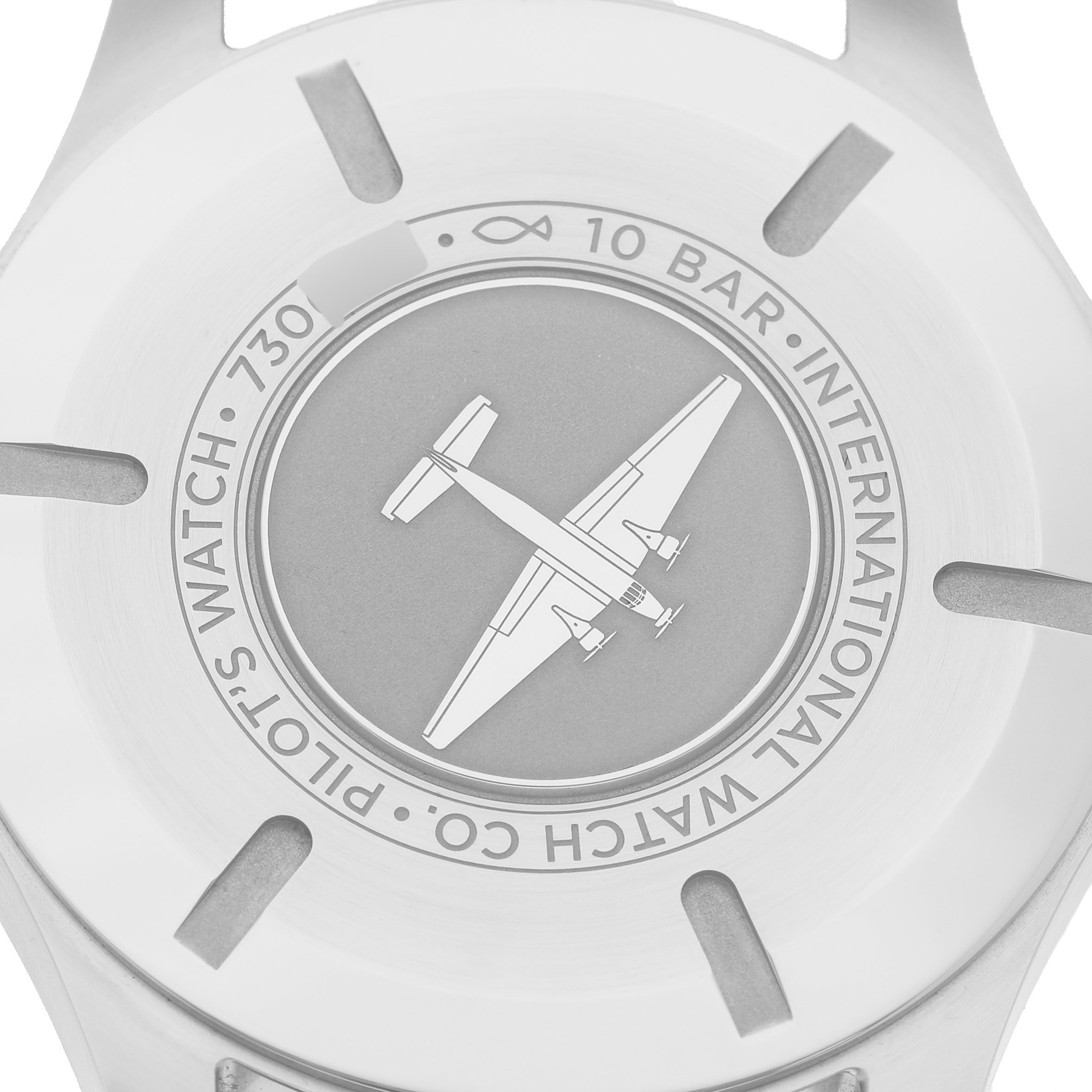 The image shows the case back of the IWC Pilot IW328203 Men's Stainless Steel Blue Dial model watch, featuring an engraved airplane.
