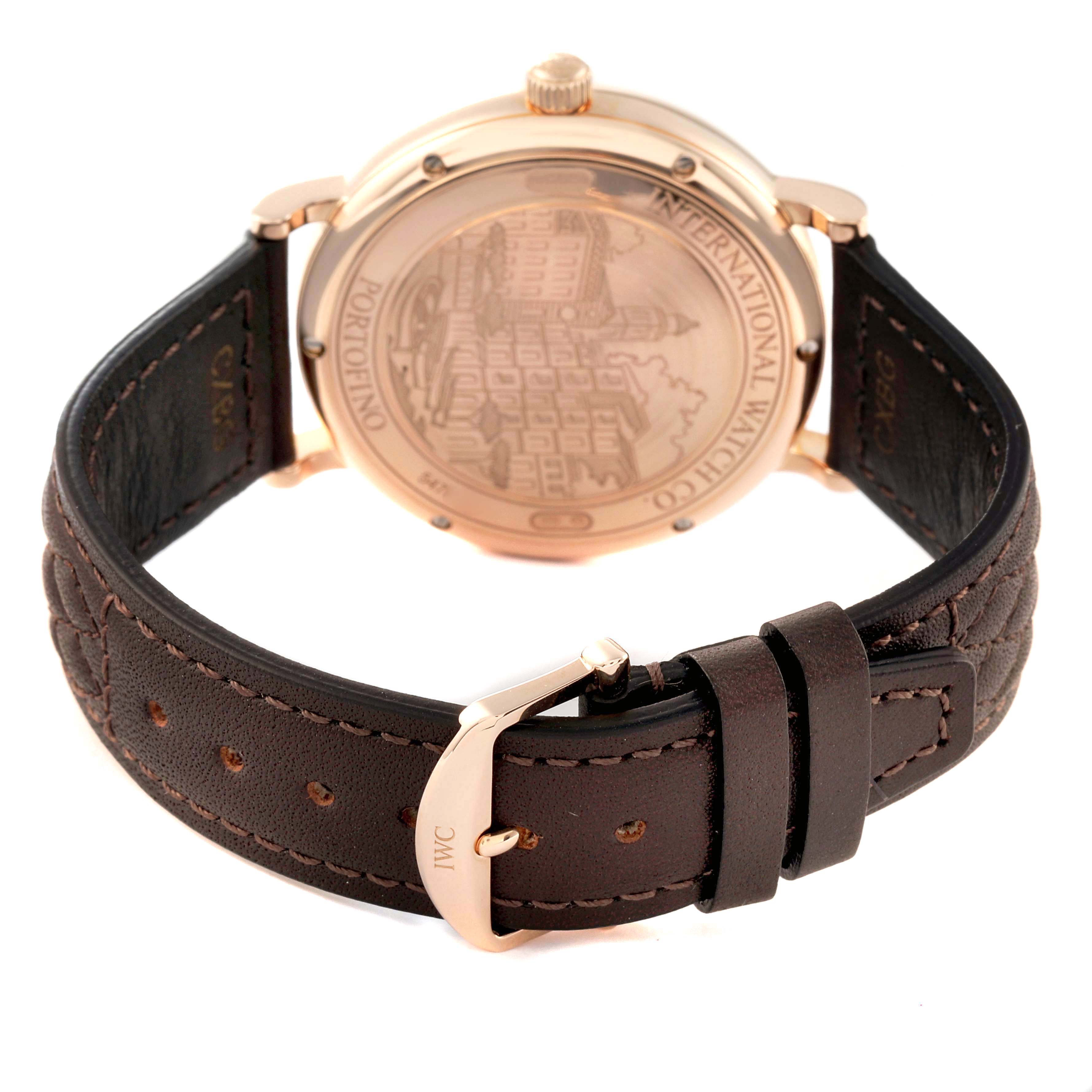 The image shows the back view of the IWC Portofino IW356504 Men's Rose Gold Silver Dial IW356504 Men's Rose Gold Silver Dial watch, highlighting the engraved case back and leather strap with the IWC buckle.