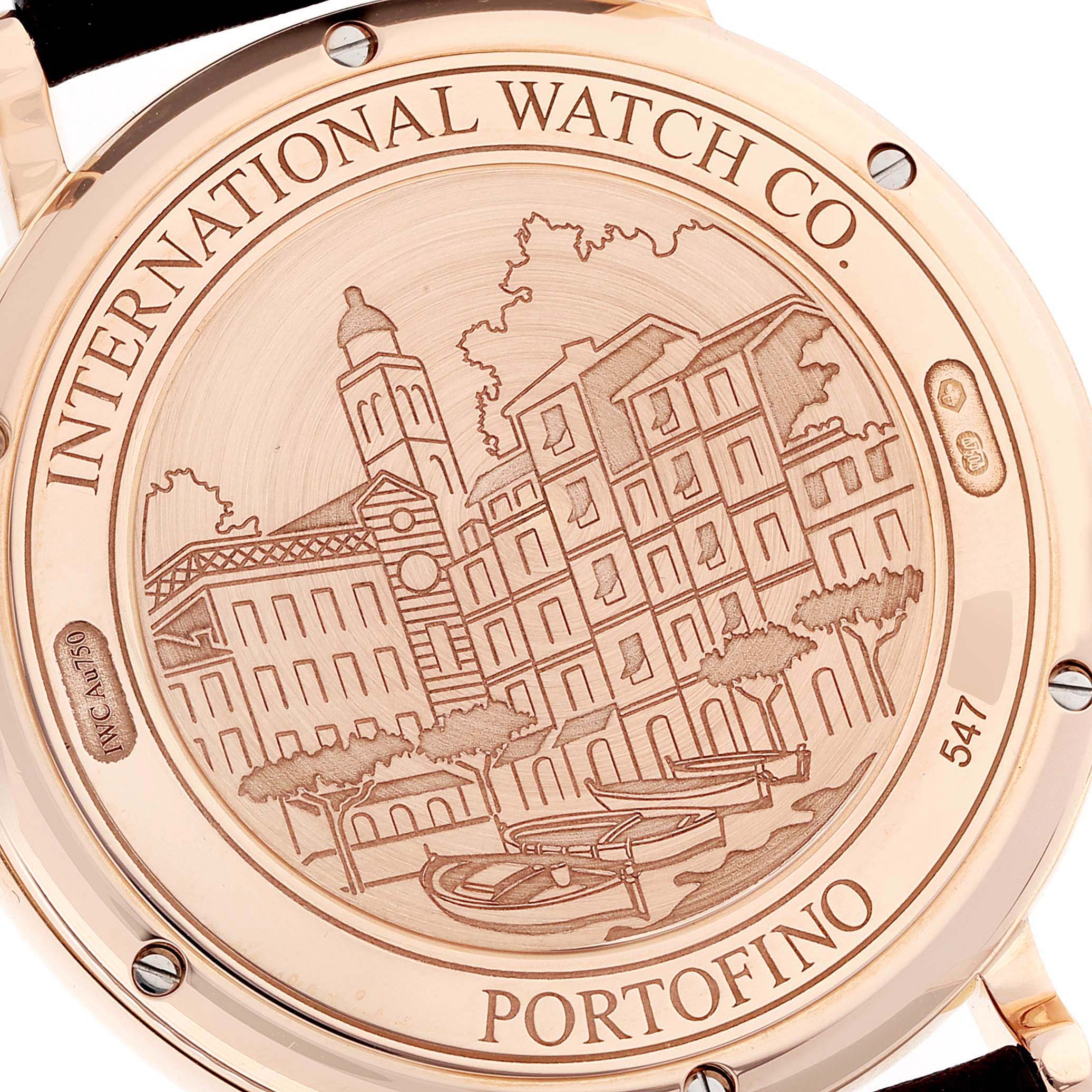 The image shows the engraved case back of an IWC Portofino IW356504 Men's Rose Gold Silver Dial IW356504 Men's Rose Gold Silver Dial watch with a cityscape design.