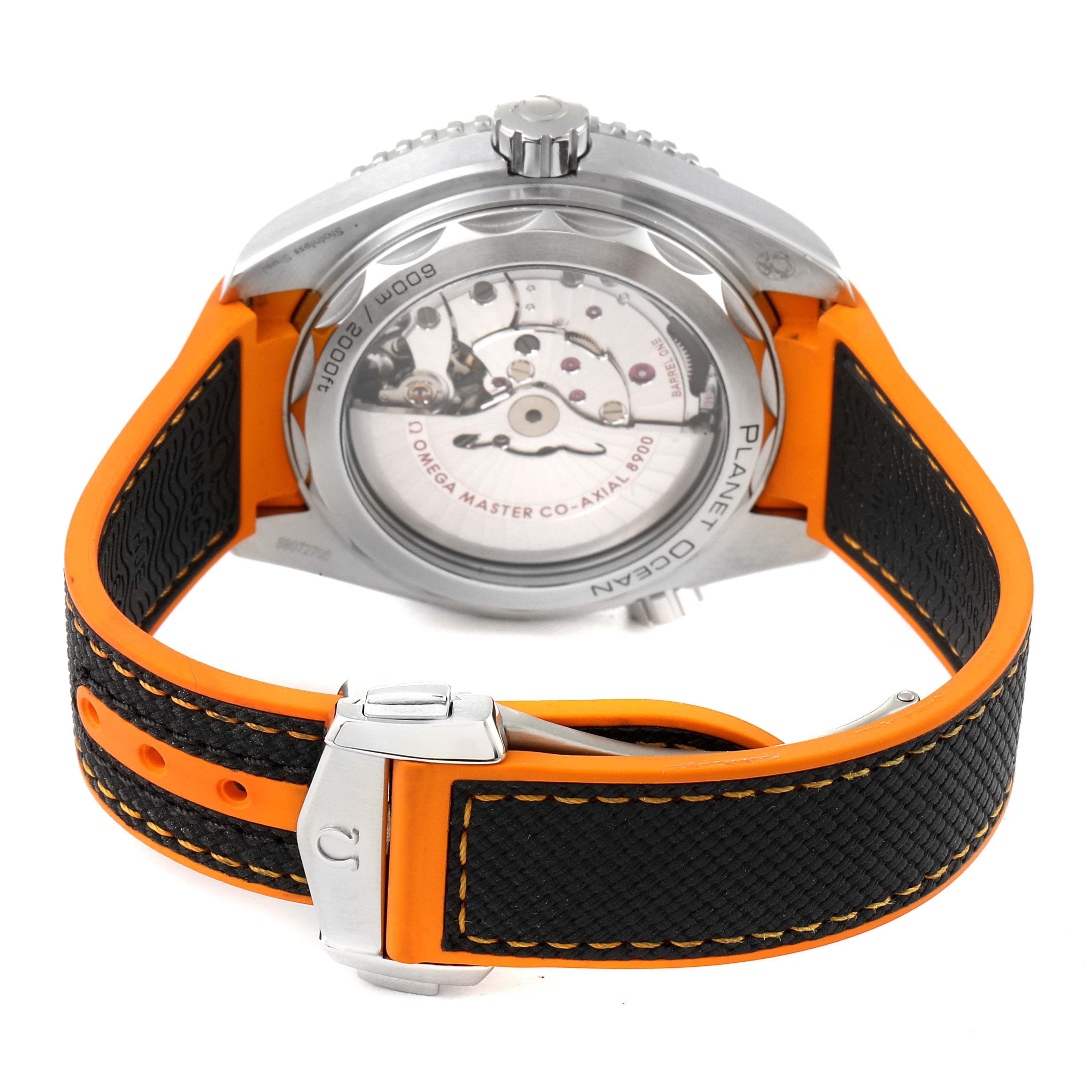 The image shows the back of the Omega Planet Ocean 215.32.44.21.01.001 Men's Stainless Steel Black Dial 215.32.44.21.01.001 Men's Stainless Steel Black Dial watch, highlighting the movement through the transparent case back and orange-black strap.