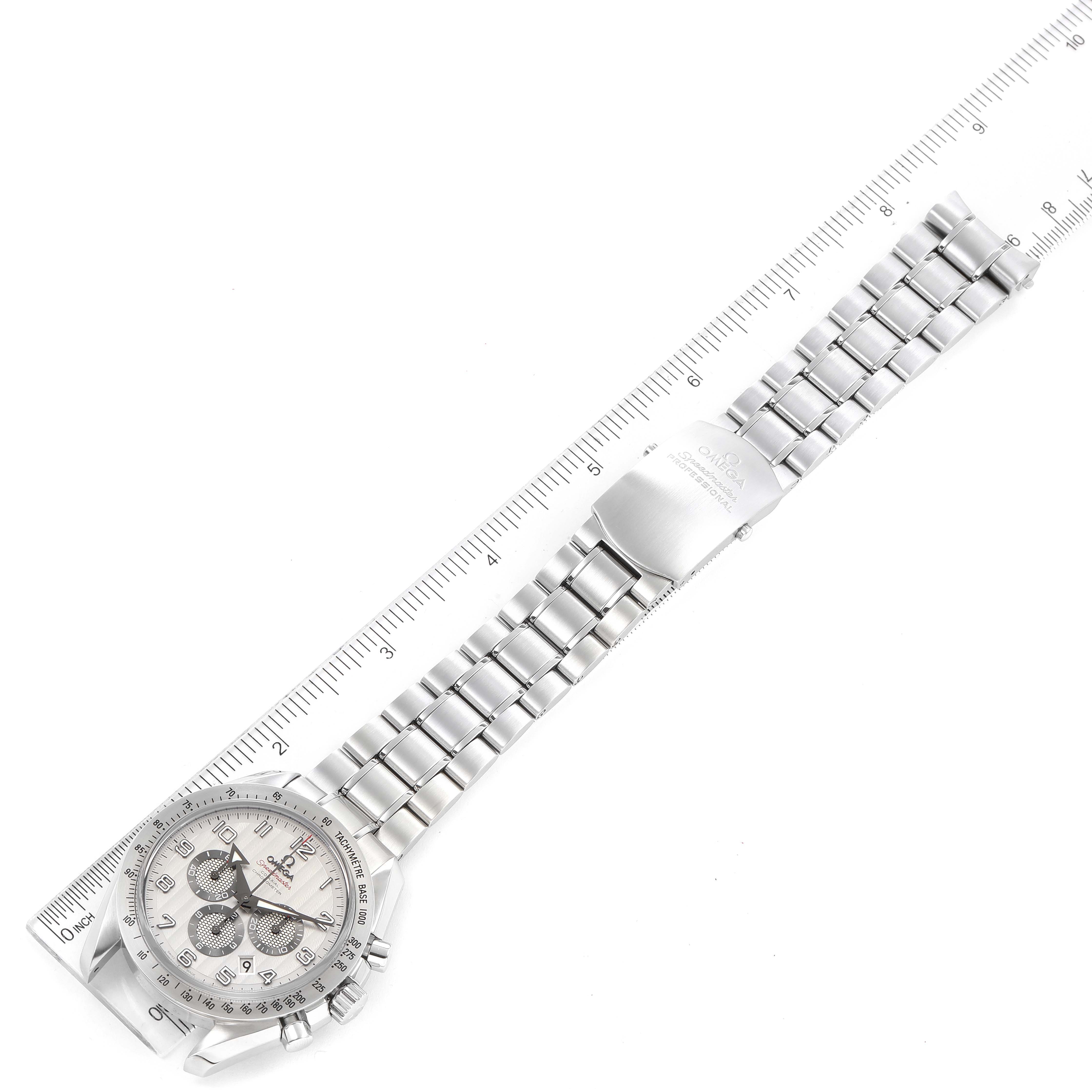 The image shows the Omega Speedmaster 321.10.44.50.02.001 Men's Stainless Steel Silver Dial 321.10.44.50.02.001 Men's Stainless Steel Silver Dial watch laid flat with its stainless steel bracelet extended alongside a ruler for measurement.