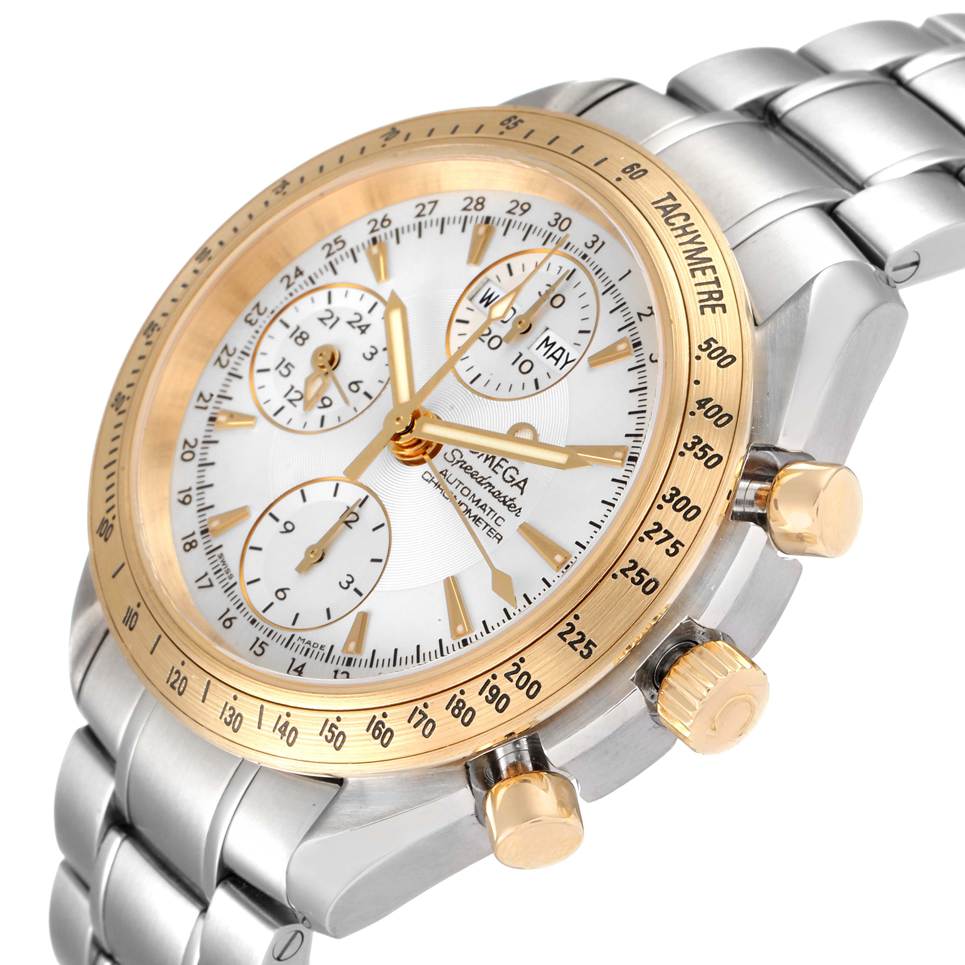 The image shows an oblique close-up of an Omega Speedmaster 323.21.40.44.02.001 Men's Steel and Gold (two tone) Silver Dial 323.21.40.44.02.001 Men's Steel and Gold (two tone) Silver Dial watch, highlighting the dial, bezel, pushers, and part of the bracelet.