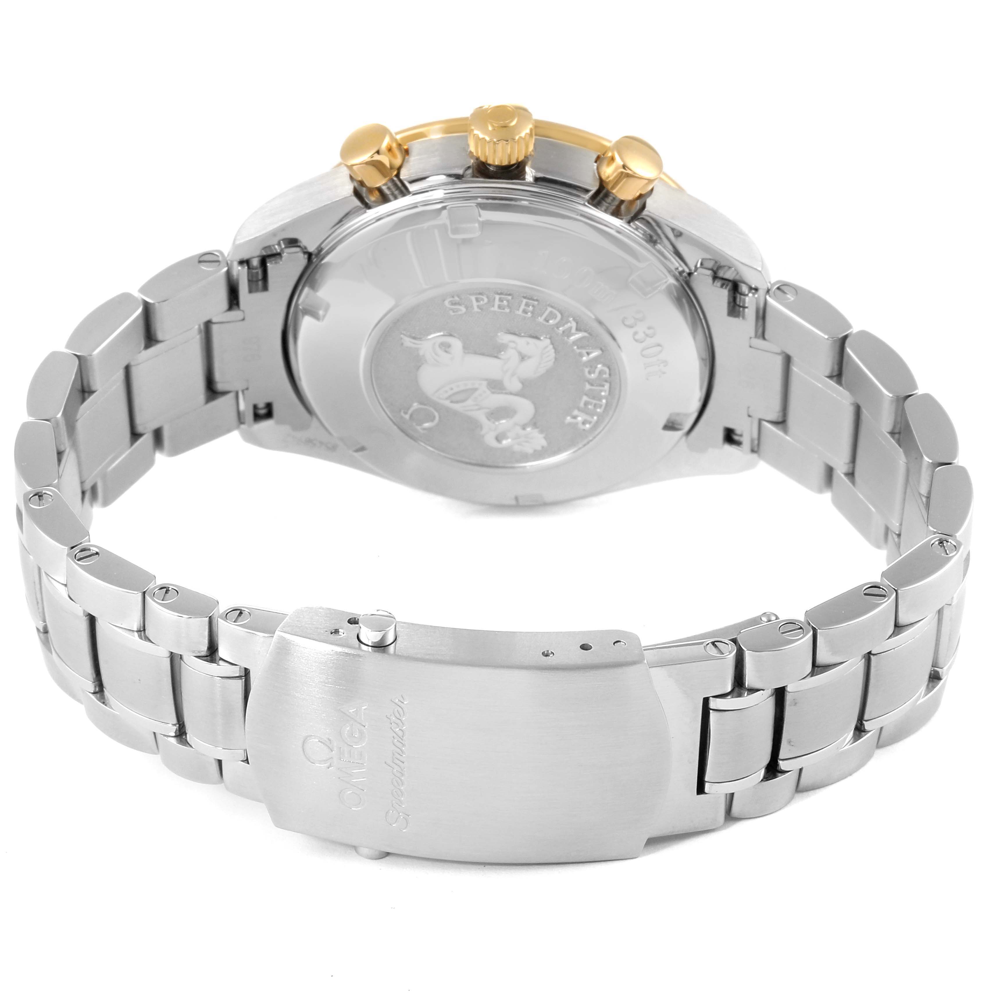 The image shows the back and bracelet of an Omega Speedmaster 323.21.40.44.02.001 Men's Steel and Gold (two tone) Silver Dial 323.21.40.44.02.001 Men's Steel and Gold (two tone) Silver Dial watch with a metal band and gold-tone pushers.