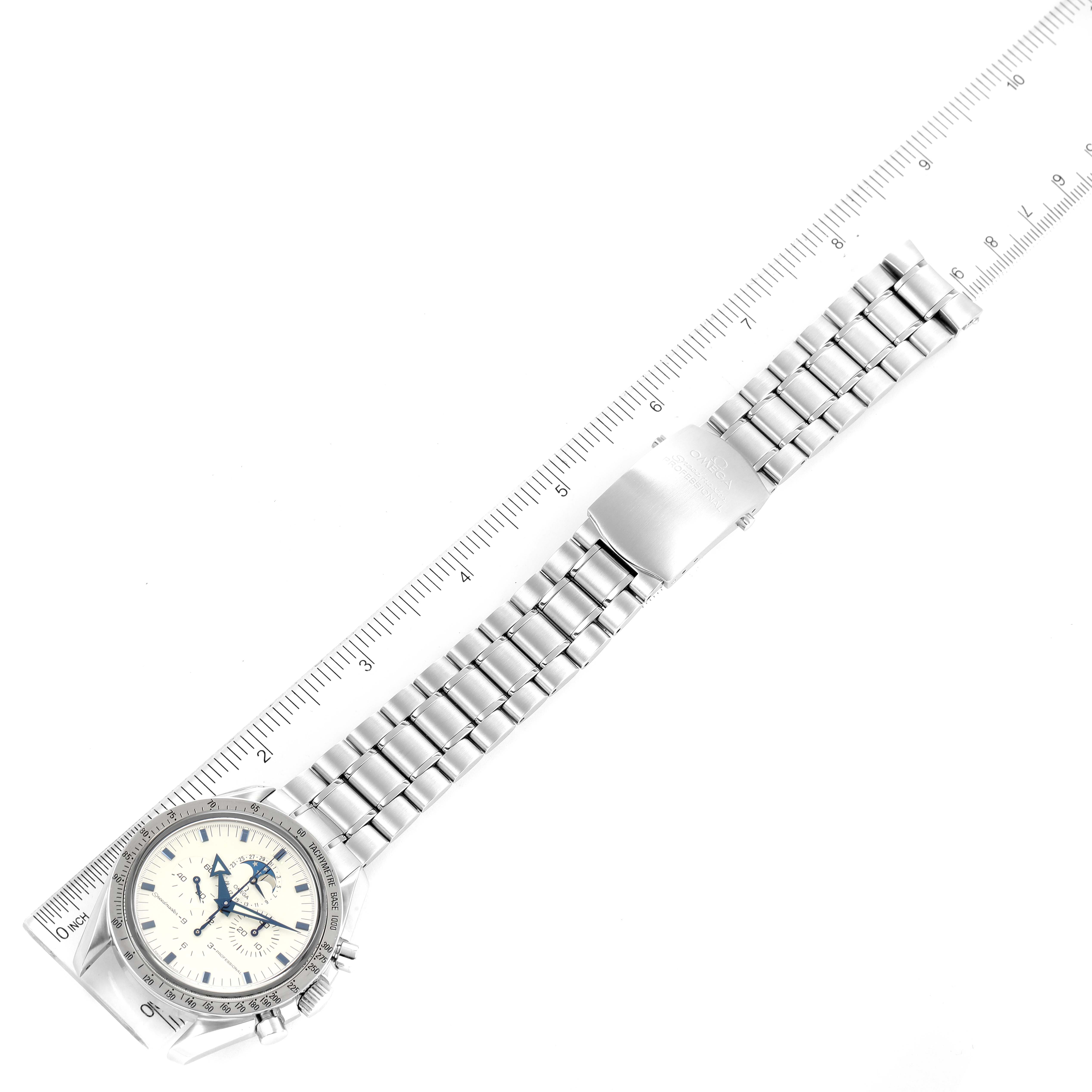 The image shows an Omega Speedmaster 3575.20.00 Men's Stainless Steel White Dial 3575.20.00 Men's Stainless Steel White Dial watch laid flat with a full view of the stainless steel bracelet and clasp next to a ruler for scale.